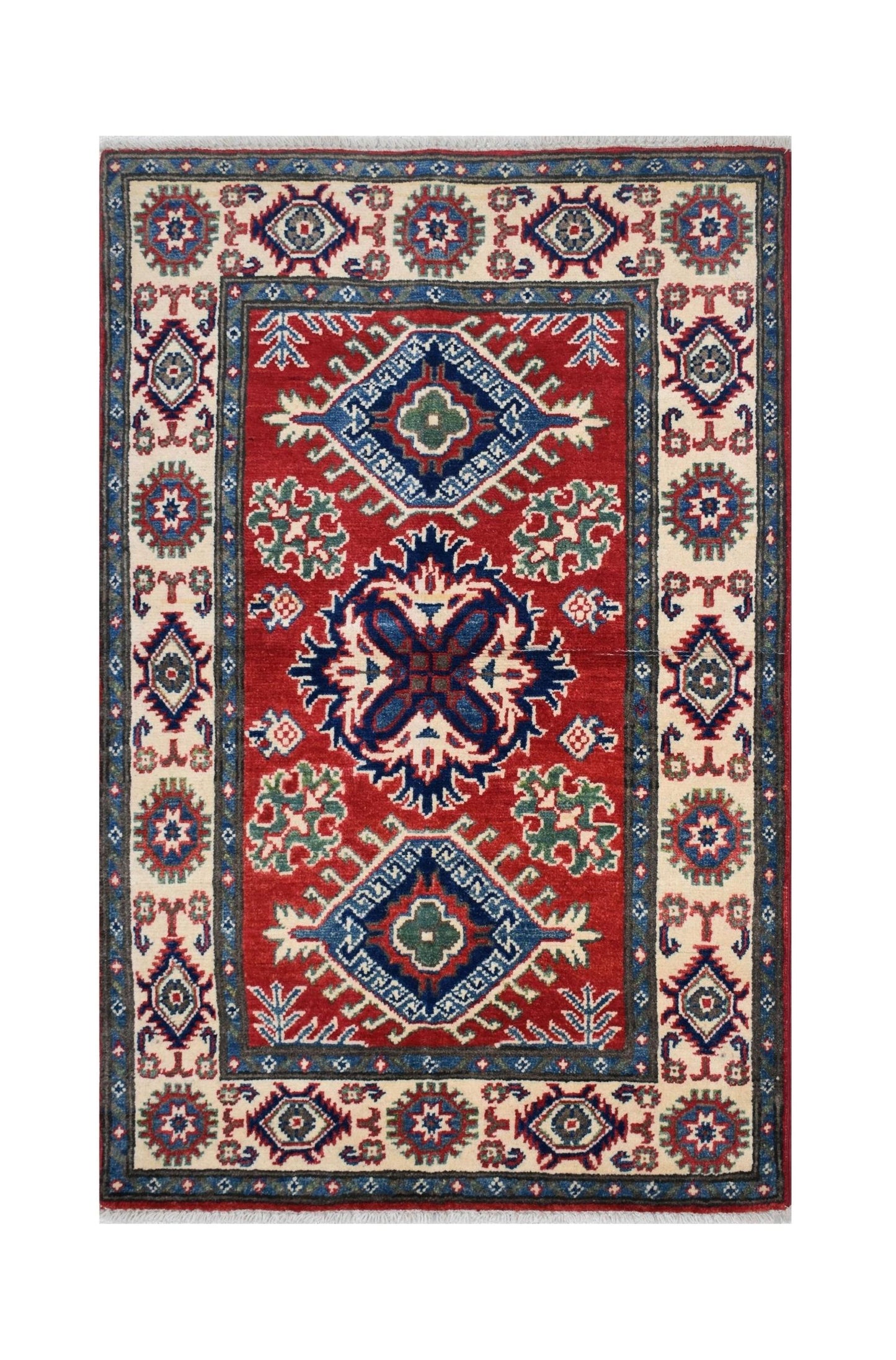 Handmade Afghan Kazakh rug featuring a red field with geometric medallions and a patterned border.
