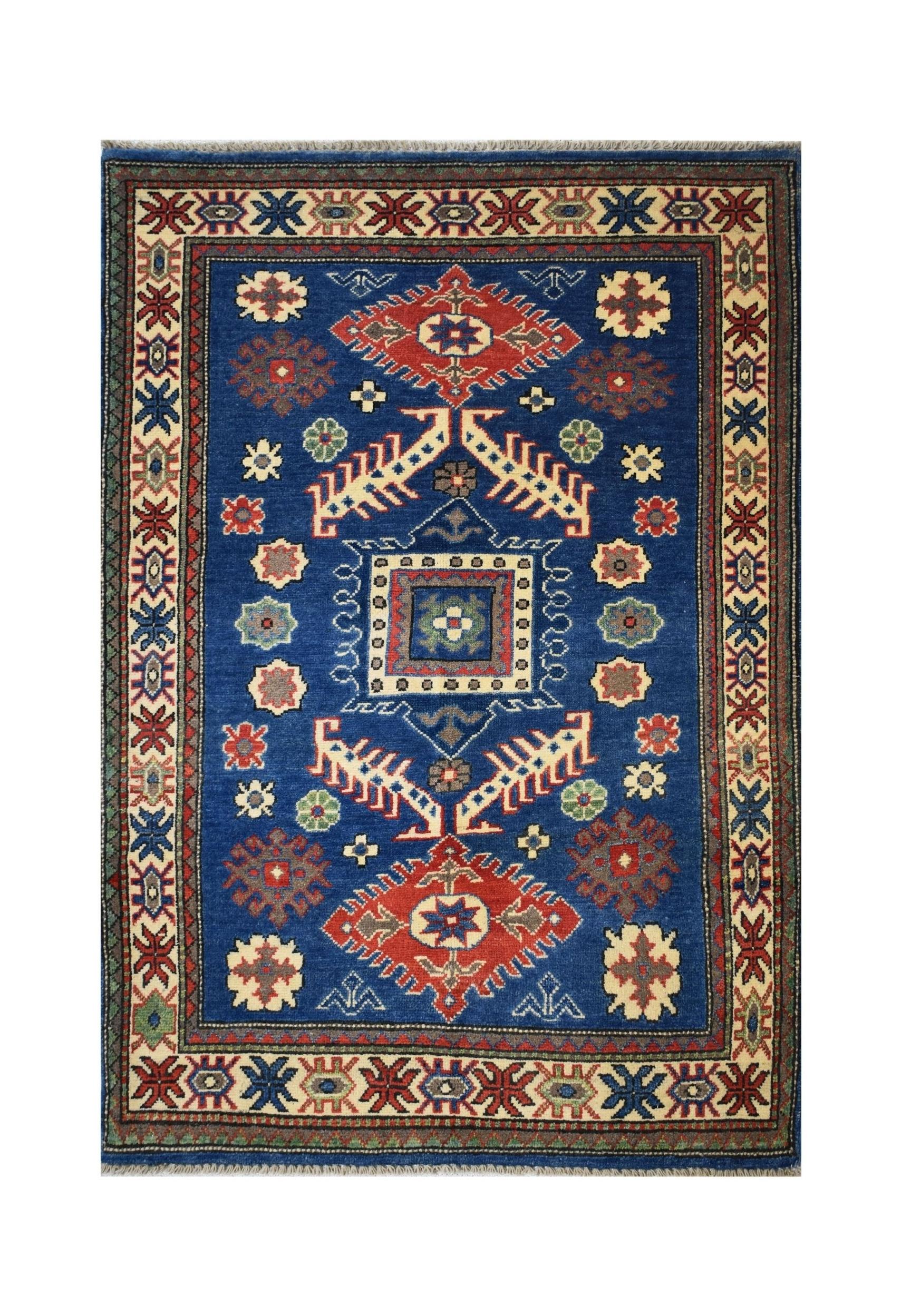 Handmade Afghan Kazakh rug featuring a blue field with geometric motifs and a patterned border.