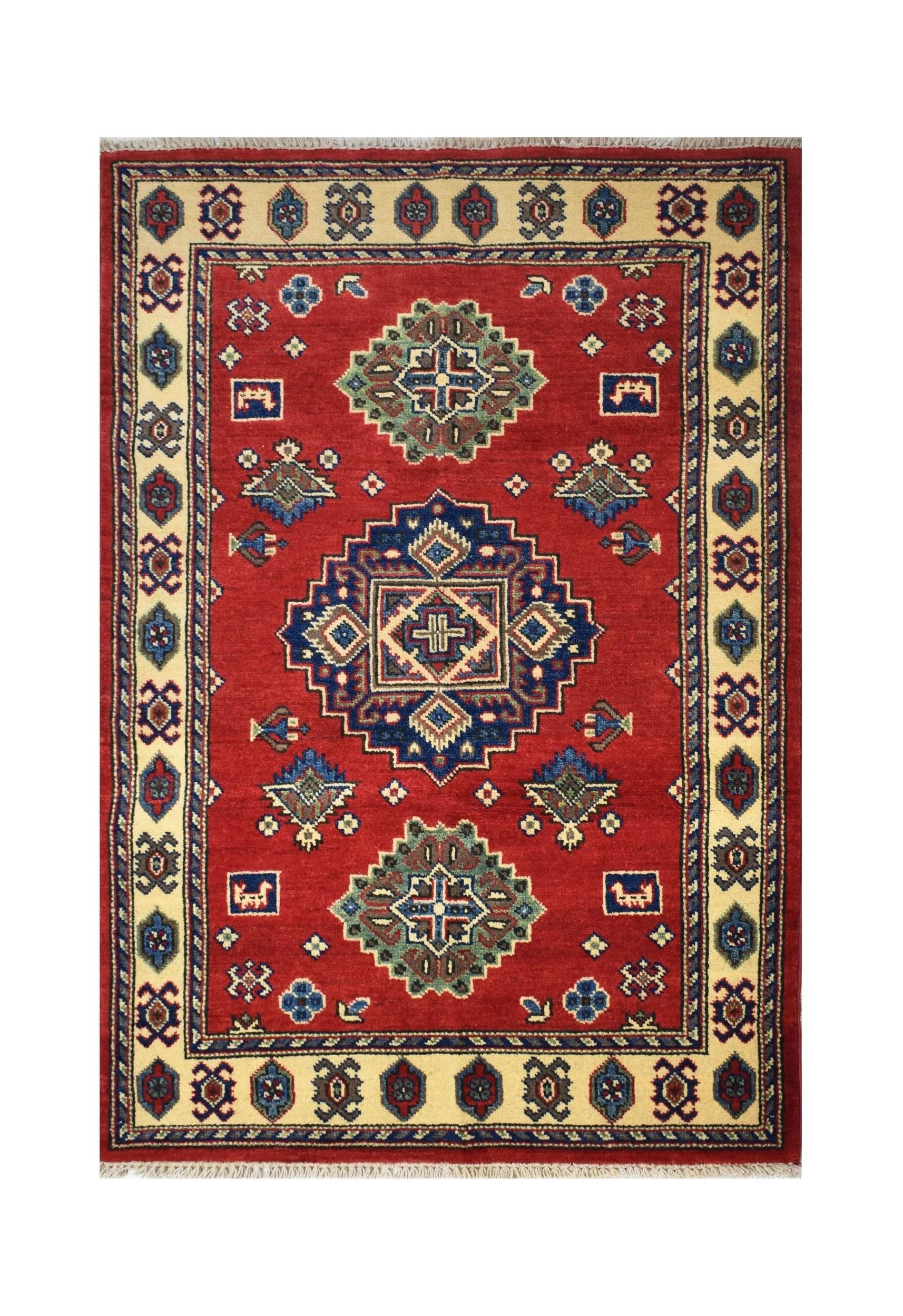 Handmade Afghan Kazakh rug featuring a geometric medallion pattern in red, blue, and cream wool.