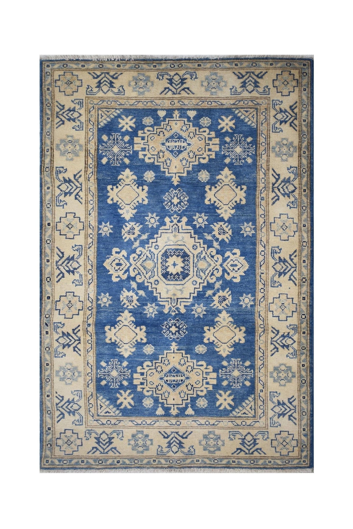 Handmade Afghan Kazakh rug featuring a blue field with cream geometric patterns and a floral border.
