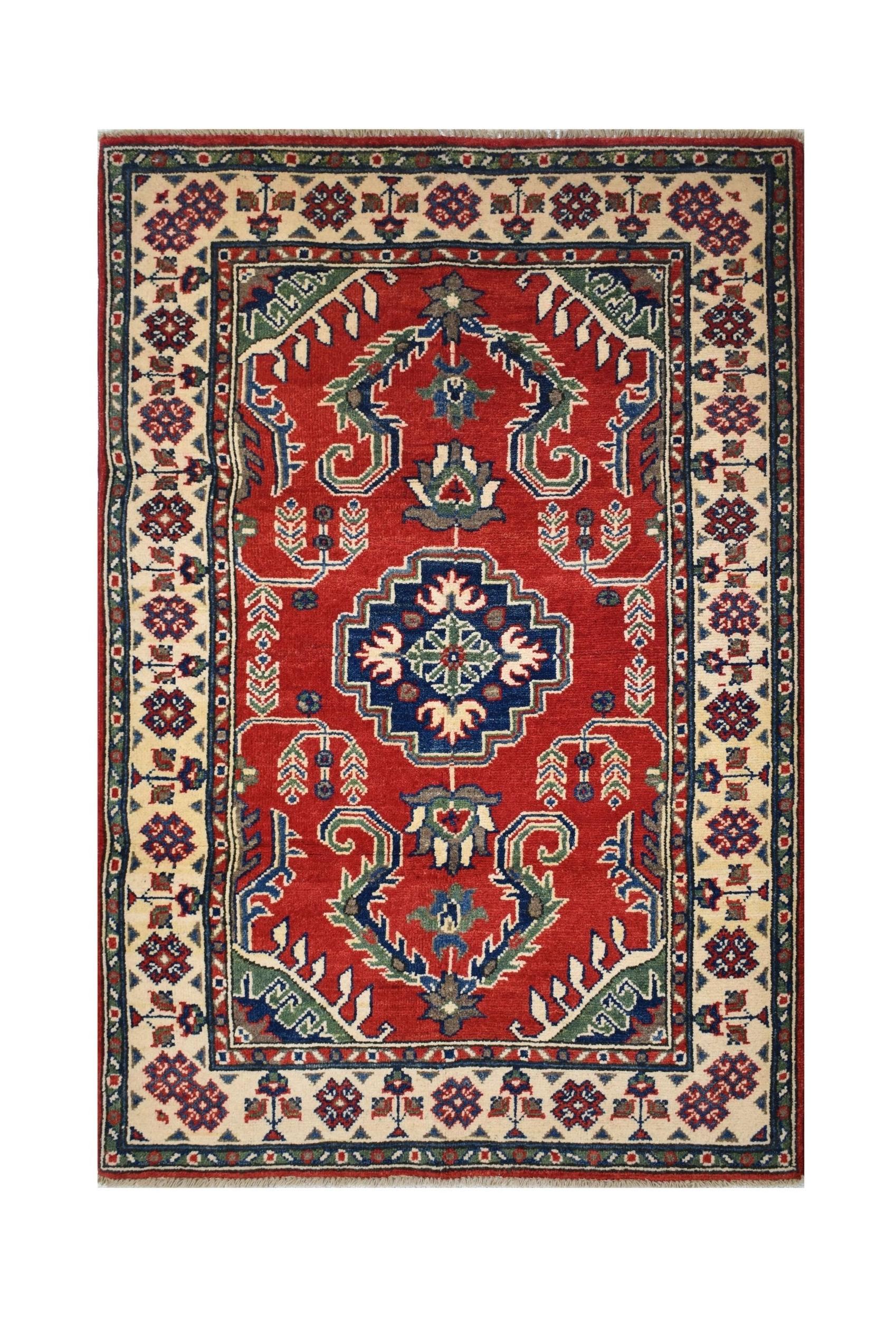 Handmade Afghan Kazakh rug featuring a central blue medallion on a red field with floral motifs.