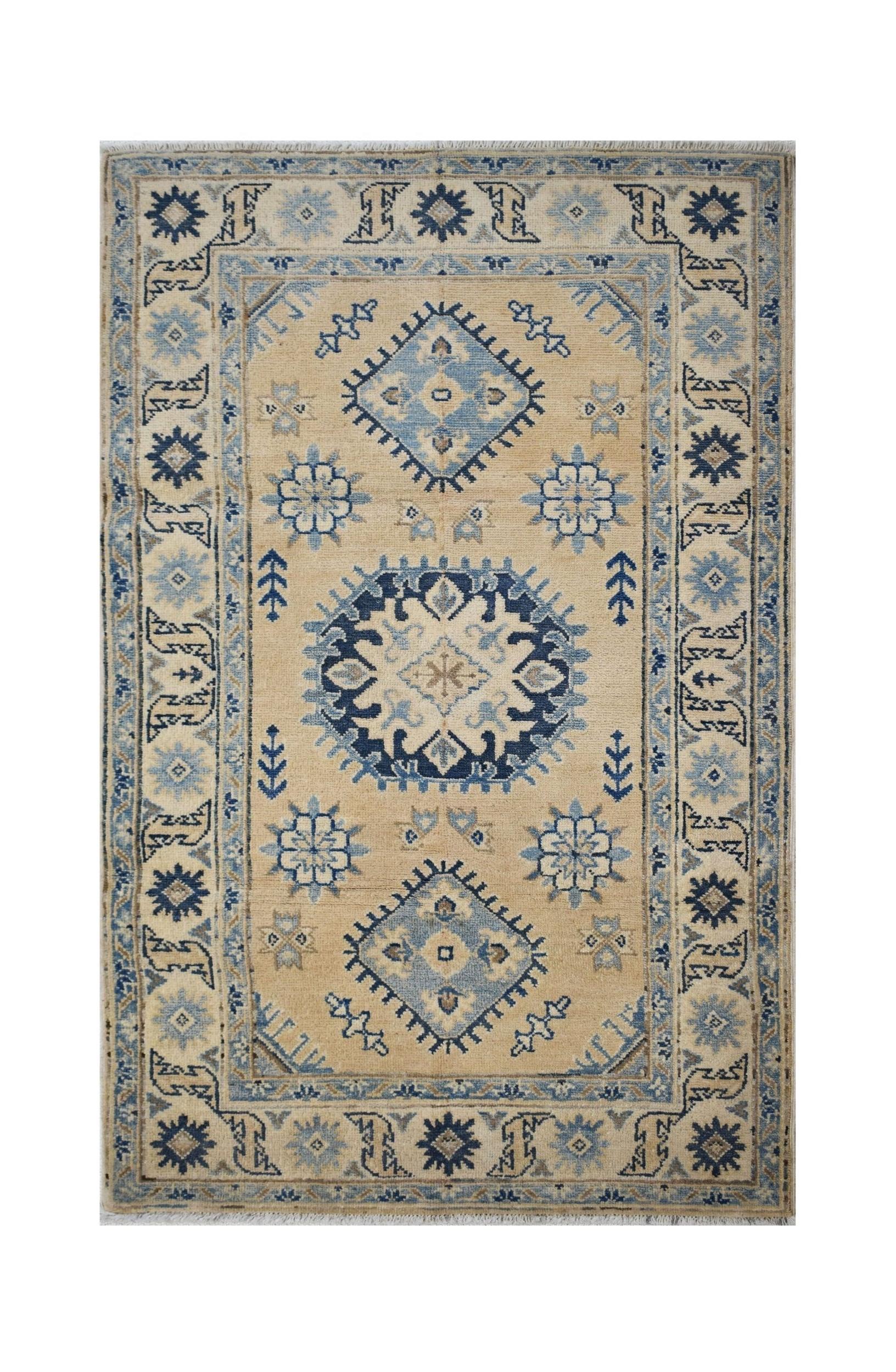 Handmade Afghan Kazakh rug featuring a traditional geometric pattern in blue and beige tones.