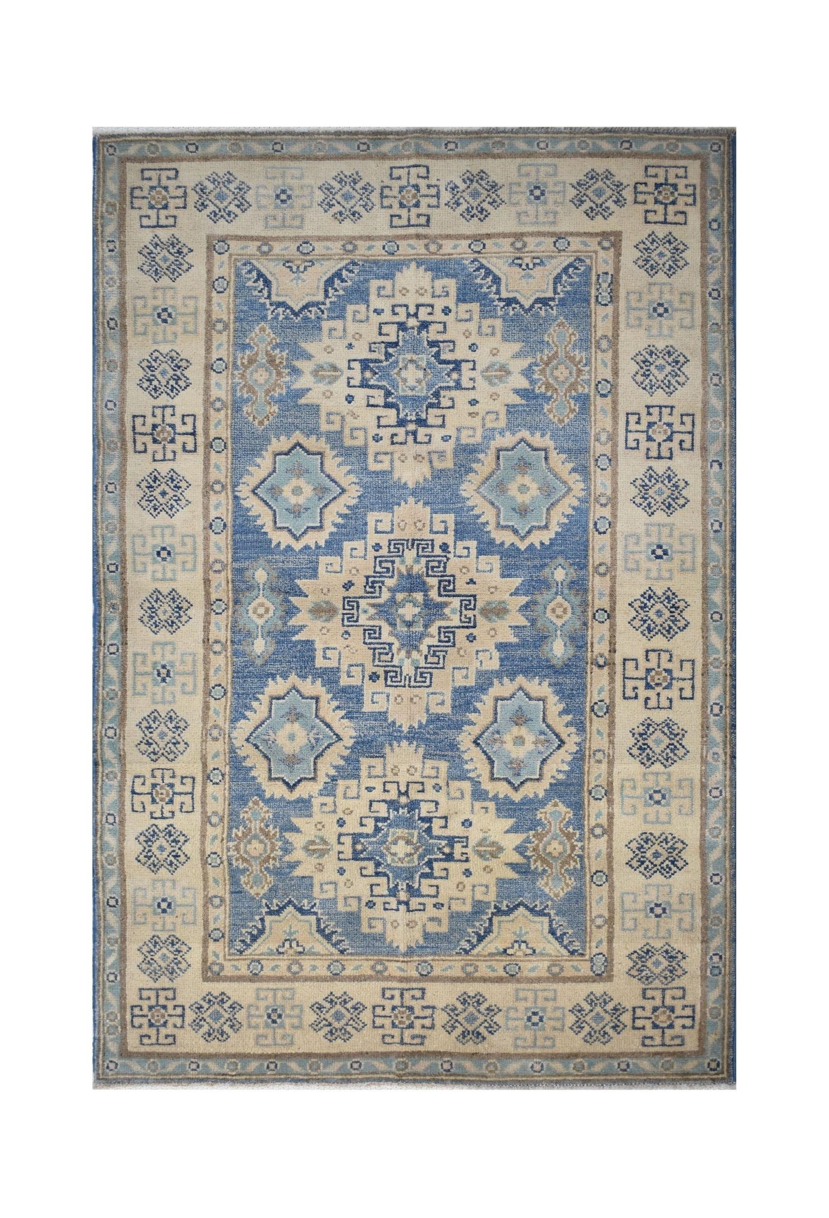 Handmade Afghan Kazakh wool rug featuring a geometric pattern in shades of blue and beige.