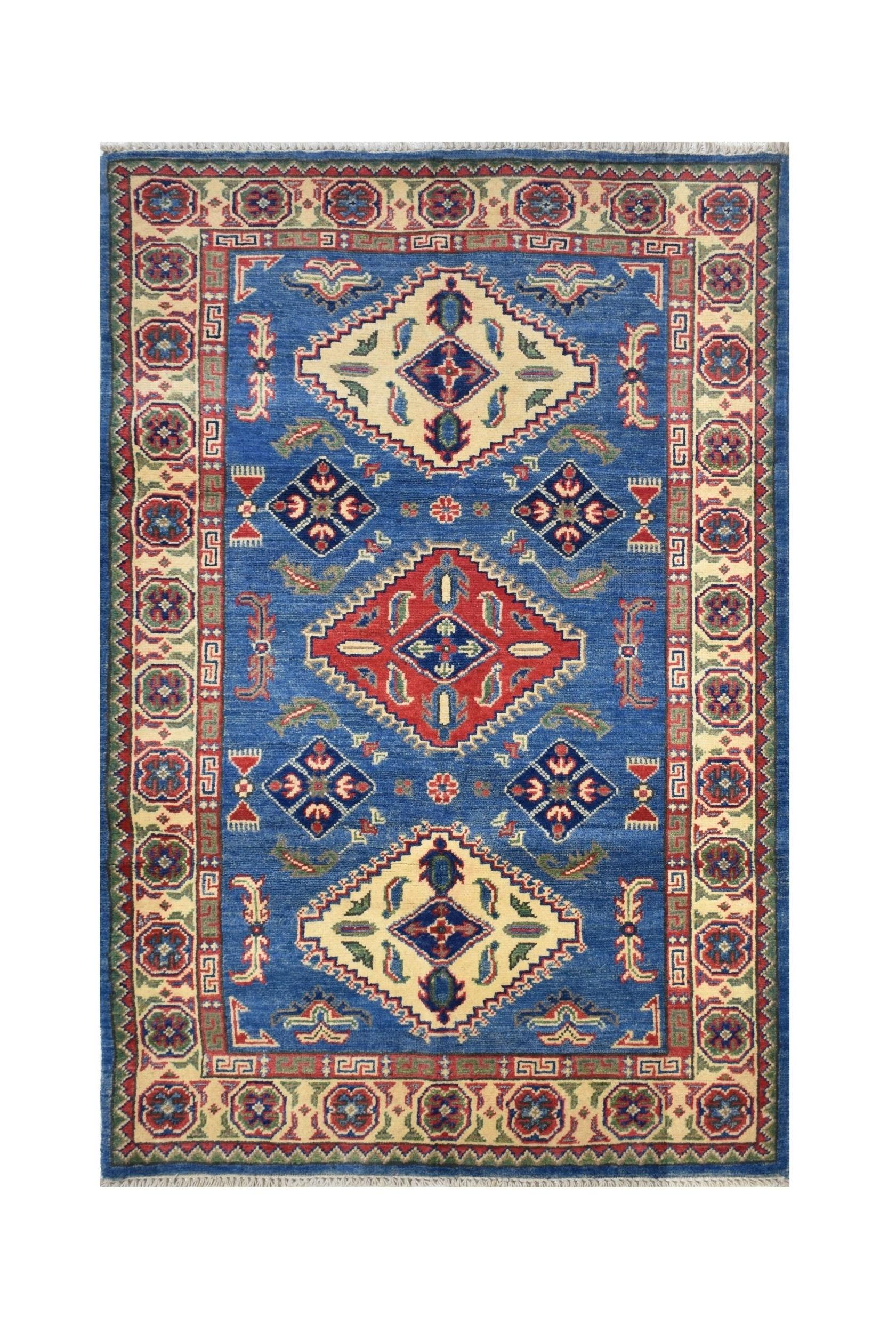 Handmade Afghan Kazakh rug featuring a blue field with geometric diamond motifs and floral accents.