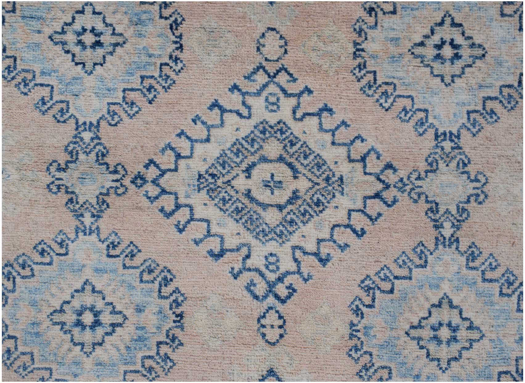 Handmade Afghan Kazakh rug featuring a blue geometric diamond pattern on a soft pink background.