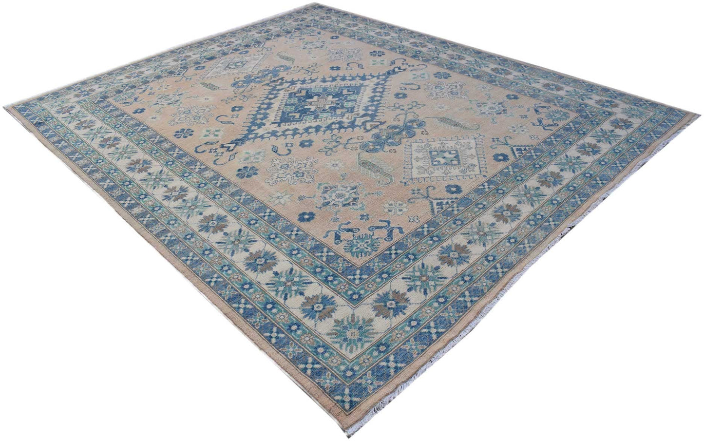 A handmade Afghan Kazakh rug featuring a beige field with blue and grey geometric patterns.