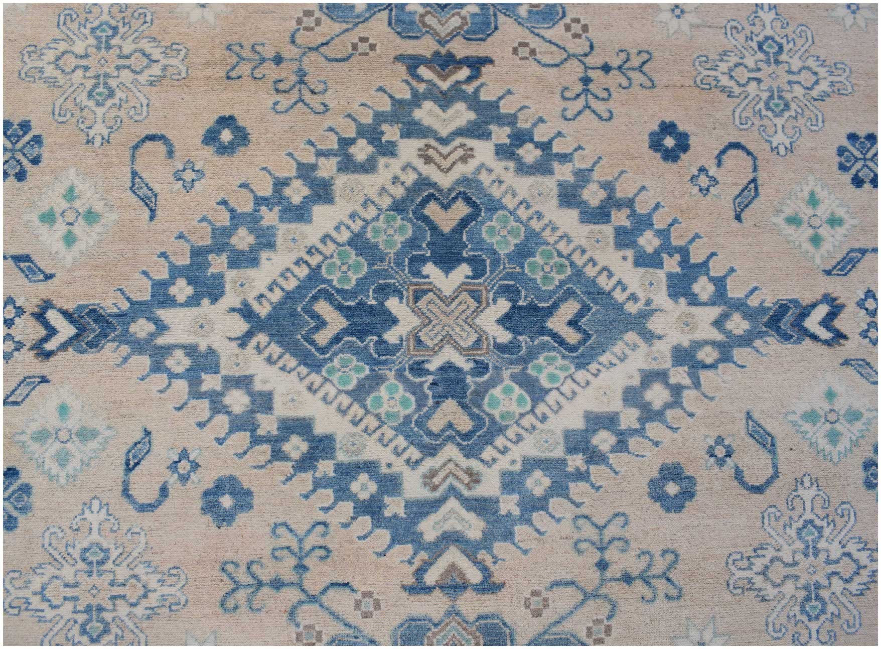 Handmade Afghan Kazakh rug featuring a central blue diamond medallion on a beige wool background.