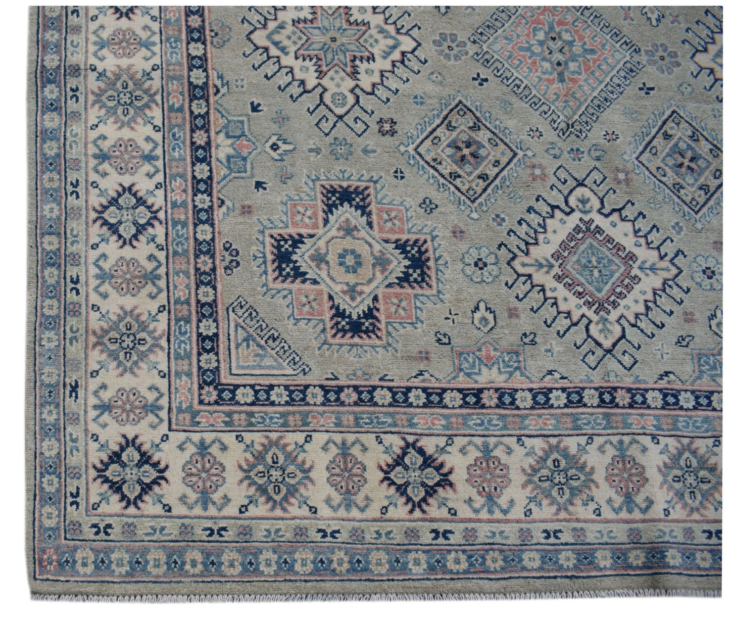 Handmade Afghan Kazakh wool rug featuring traditional geometric motifs in blue, pink, and grey.
