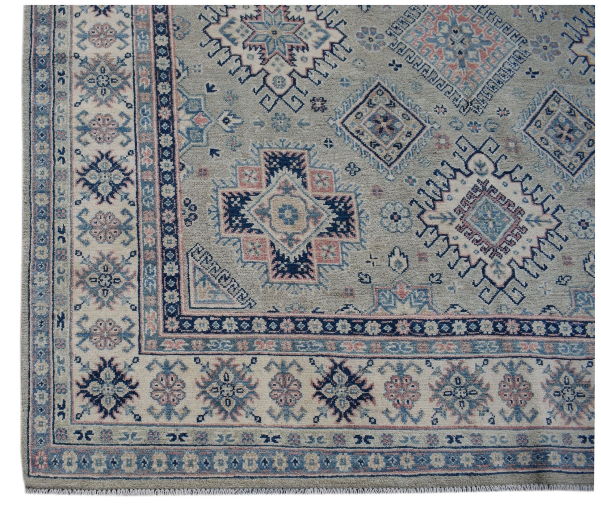 Handmade Afghan Kazakh wool rug featuring traditional geometric motifs in blue, pink, and grey.