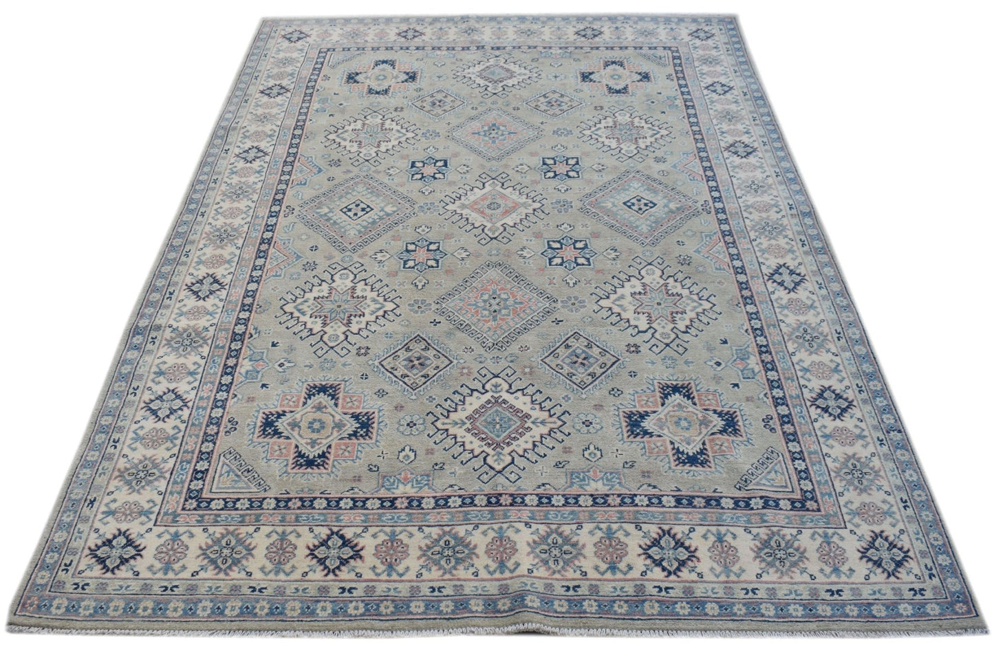 Handmade Afghan Kazakh rug featuring traditional geometric motifs in blue, pink, and beige tones.