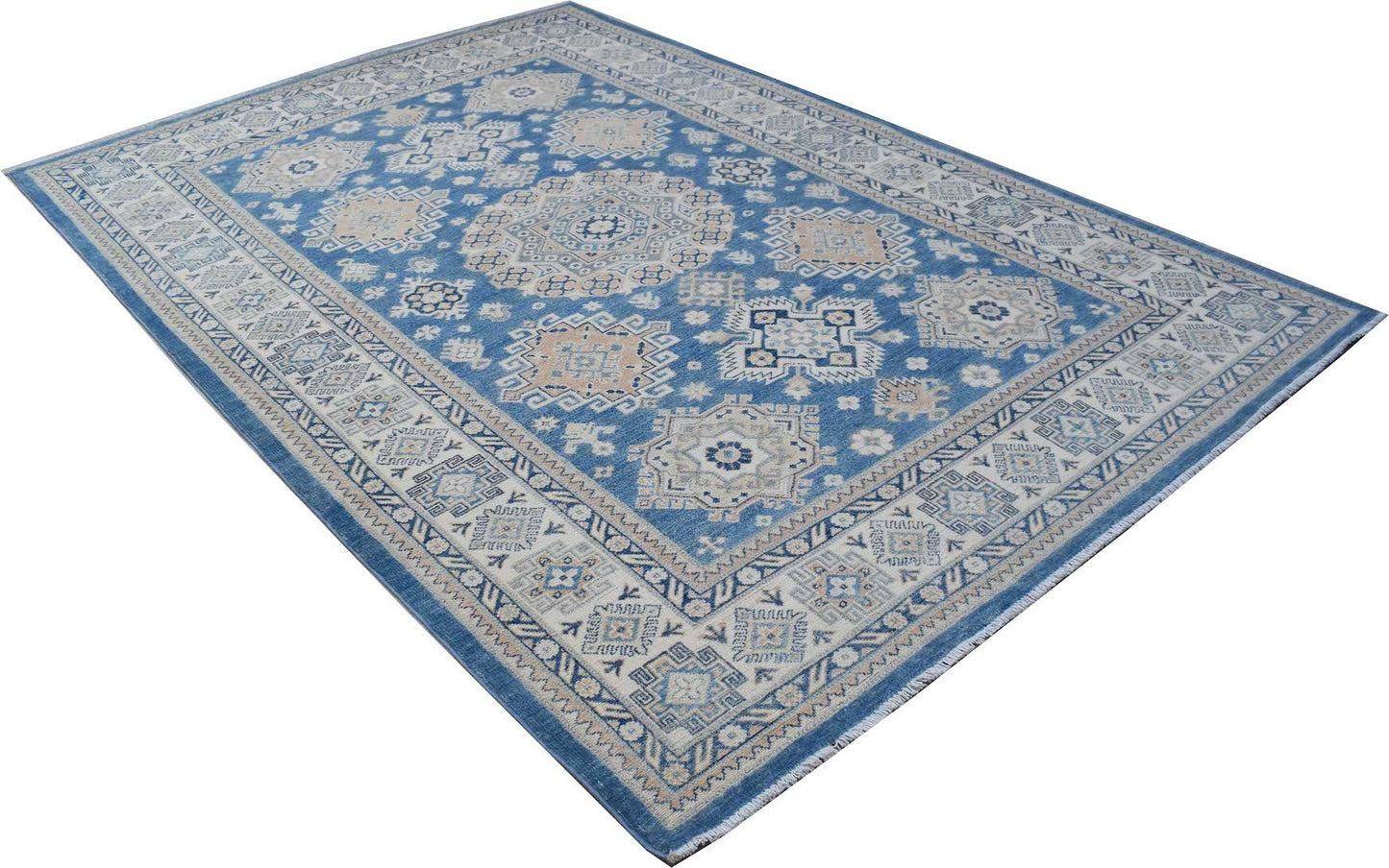 An Afghan Kazakh rug featuring a blue field with intricate beige and grey geometric patterns.