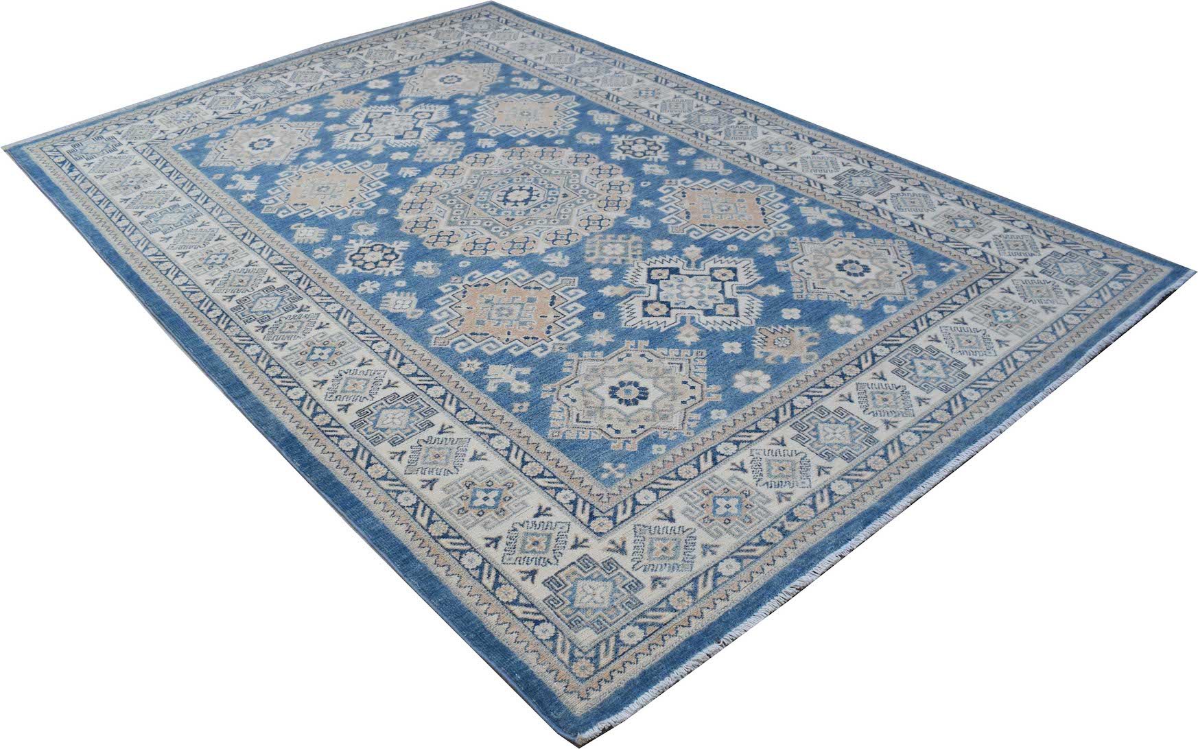 An Afghan Kazakh rug featuring a blue field with intricate beige and grey geometric patterns.