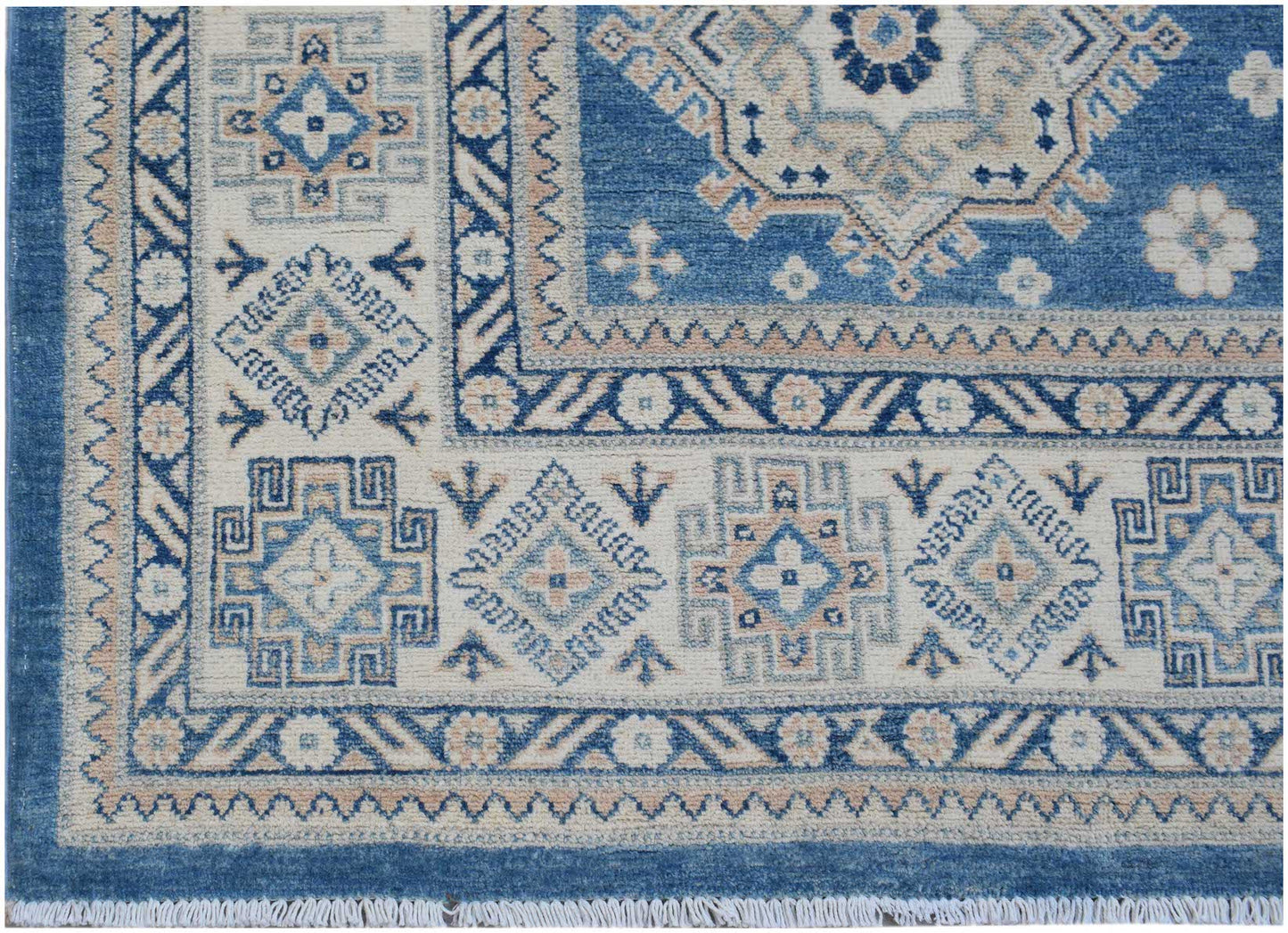 A handmade Afghan Kazakh rug featuring a geometric pattern in shades of blue, beige, and grey.