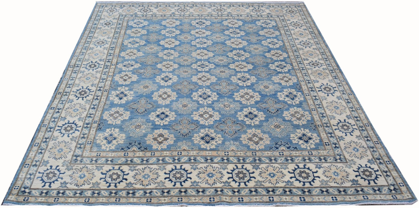 Handmade Afghan Kazakh rug featuring a repeating geometric pattern in shades of blue and beige.
