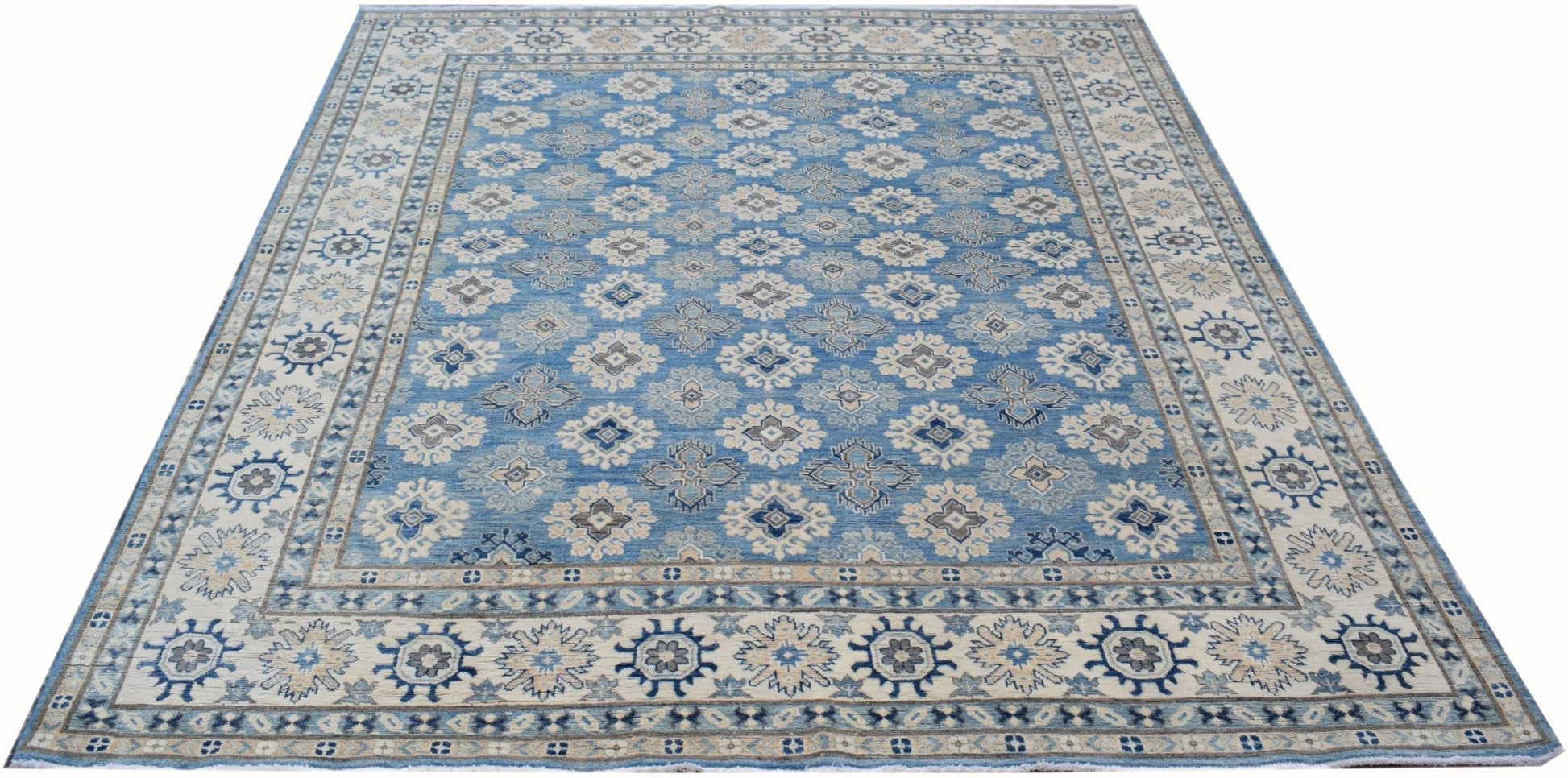 Handmade Afghan Kazakh rug featuring a repeating geometric pattern in shades of blue and beige.