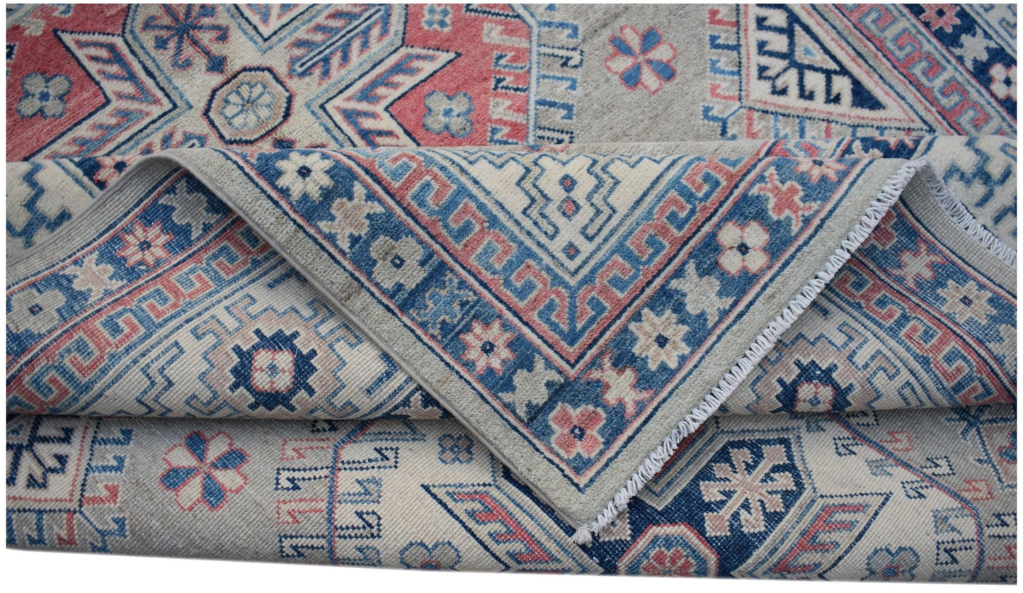 A handmade Afghan Kazakh rug featuring traditional geometric motifs in blue, red, and beige wool.