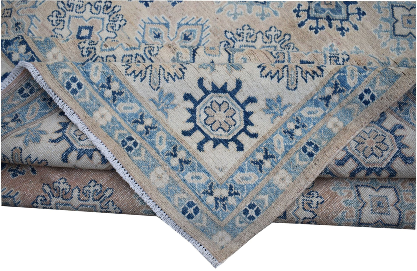 A handmade Afghan Kazakh rug featuring traditional blue and beige geometric patterns.