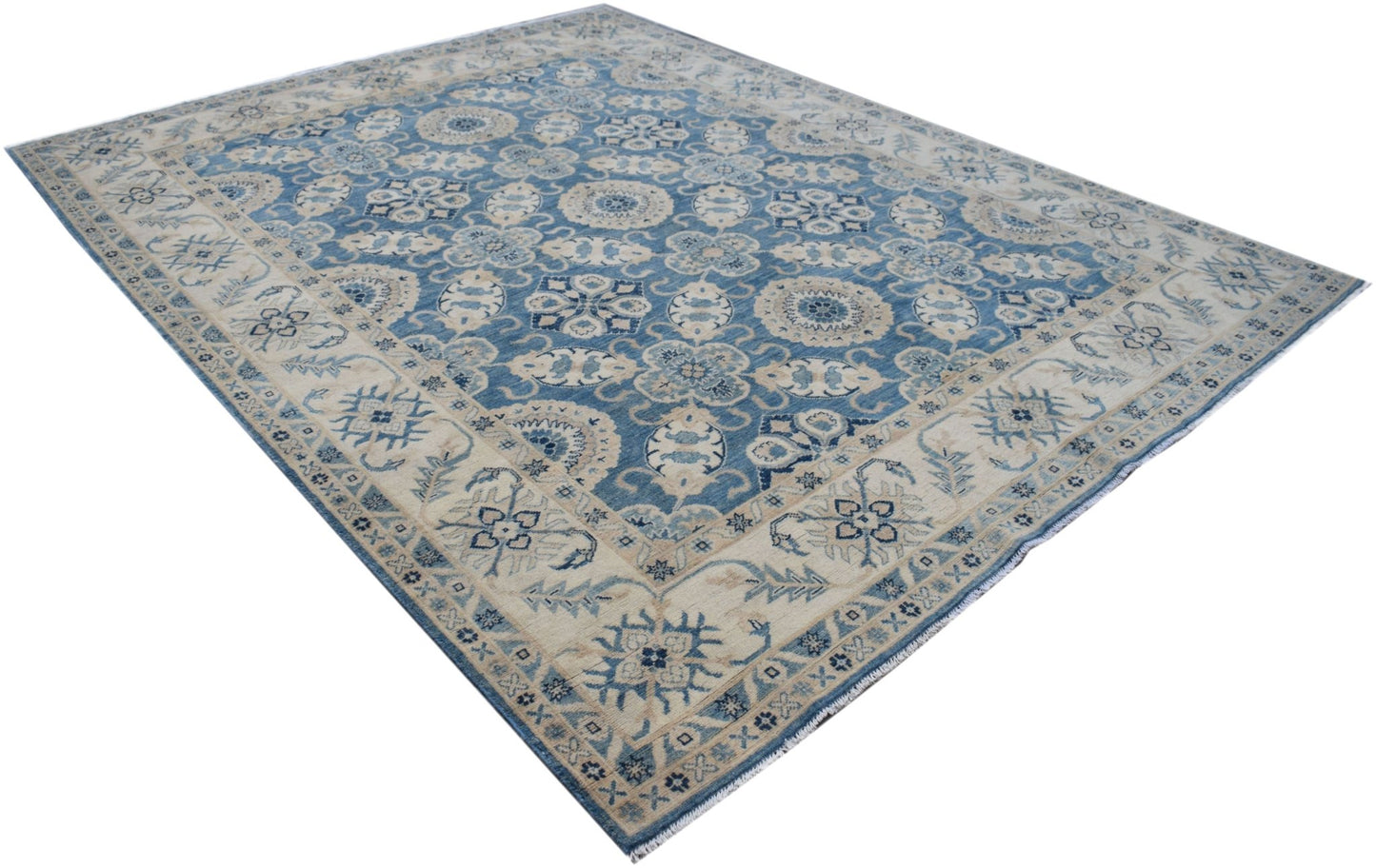 Handmade Afghan Kazakh rug featuring a traditional blue and cream floral pattern.