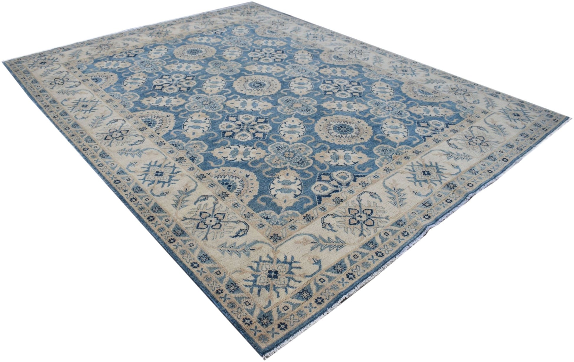 Handmade Afghan Kazakh rug featuring a traditional blue and cream floral pattern.