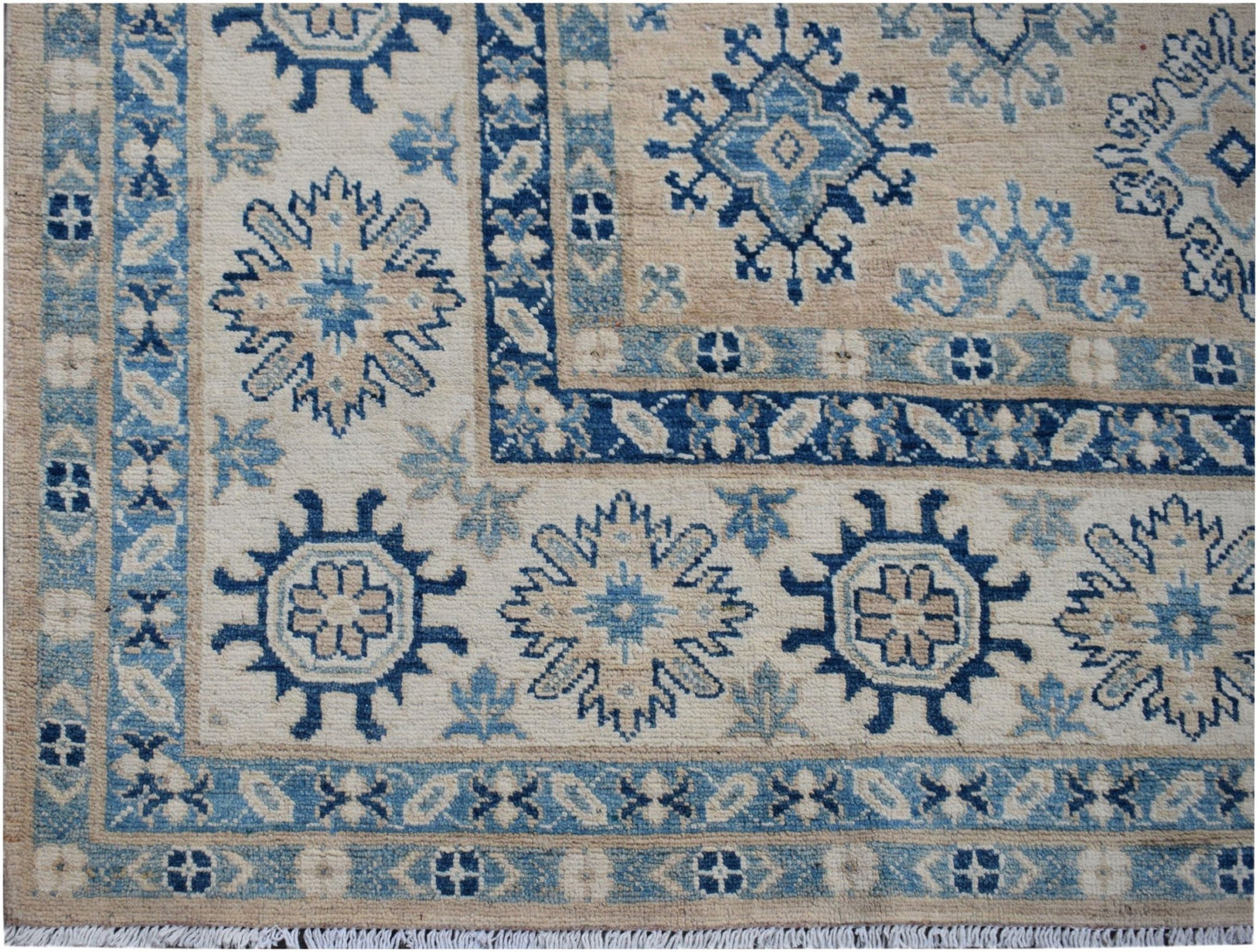 Handmade Afghan Kazakh wool rug featuring traditional blue and beige geometric floral patterns.