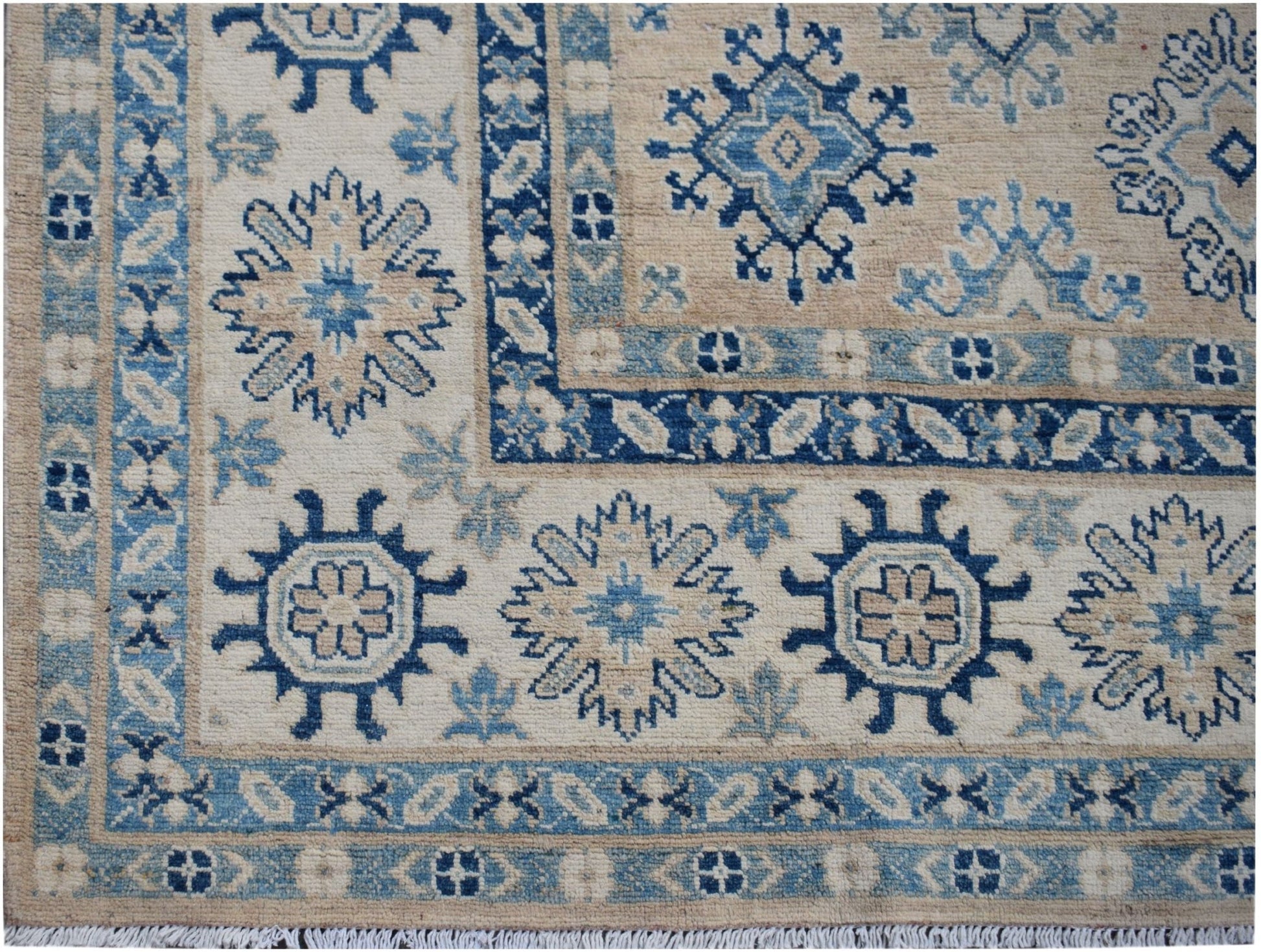 Handmade Afghan Kazakh wool rug featuring traditional blue and beige geometric floral patterns.