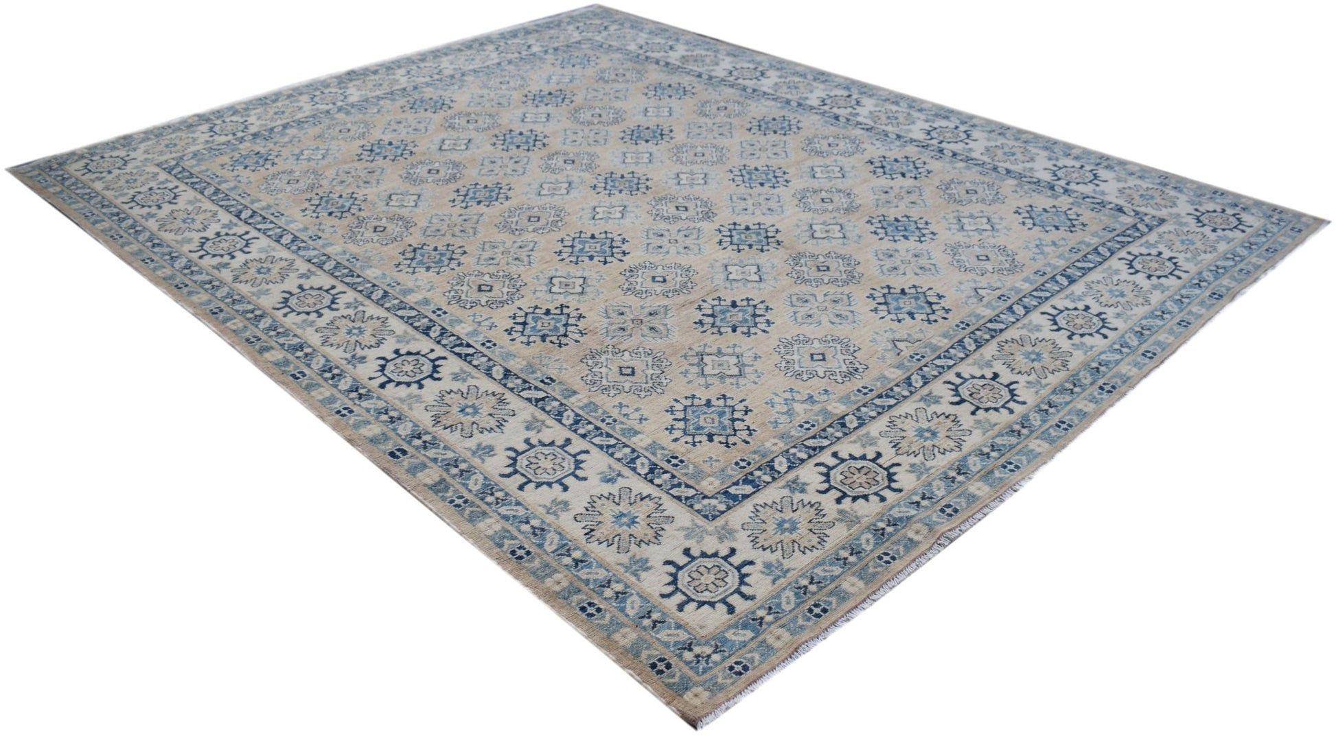 A handmade Afghan Kazakh rug featuring a traditional blue and beige geometric pattern.
