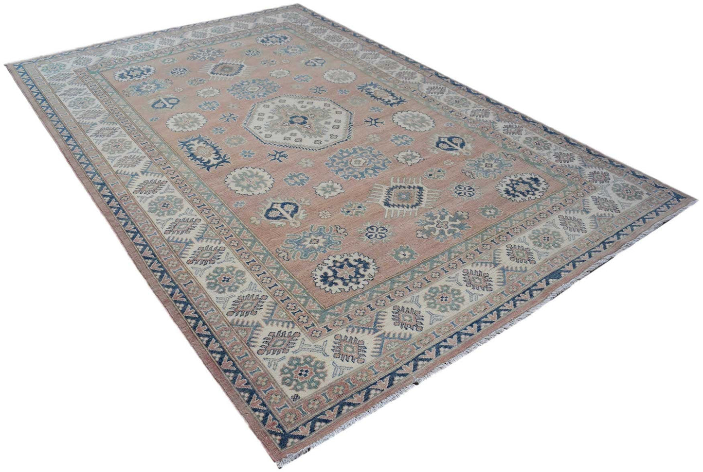 Handmade Afghan Kazakh rug featuring traditional geometric motifs in blue and cream on a pink field.