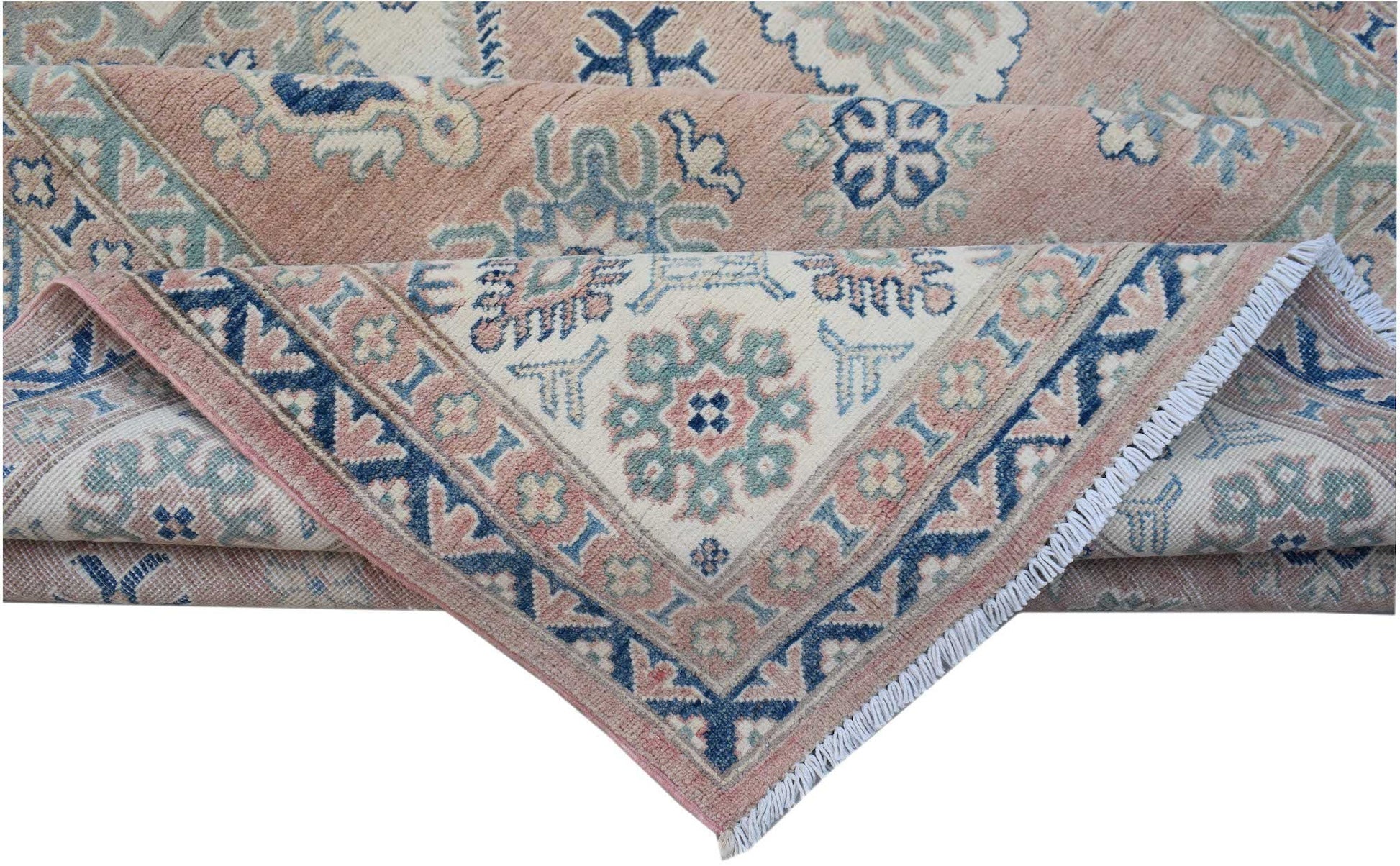 A folded Afghan Kazakh rug featuring traditional geometric motifs in blue, cream, and dusty pink.