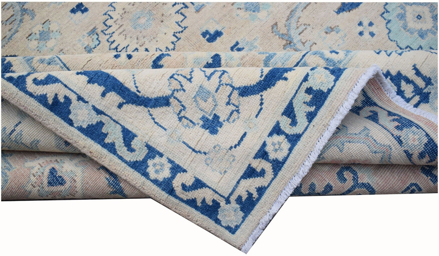 A handmade Afghan Kazakh rug featuring traditional blue and cream geometric patterns.