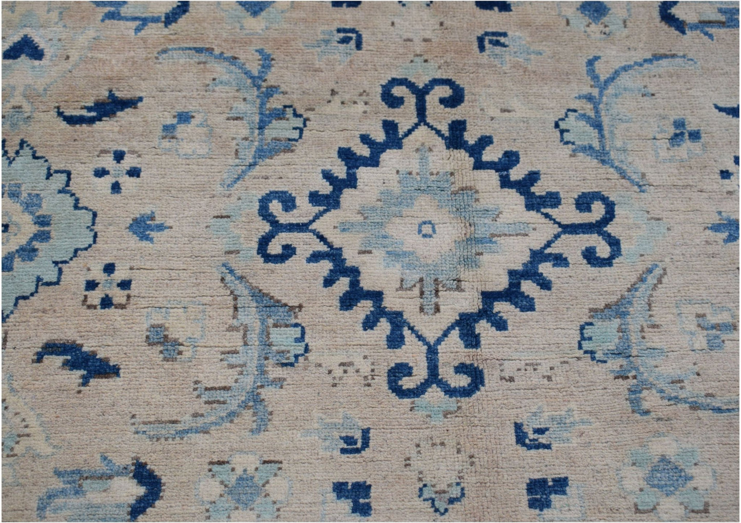 Handmade Afghan Kazakh rug featuring a traditional blue and light blue geometric pattern on wool.