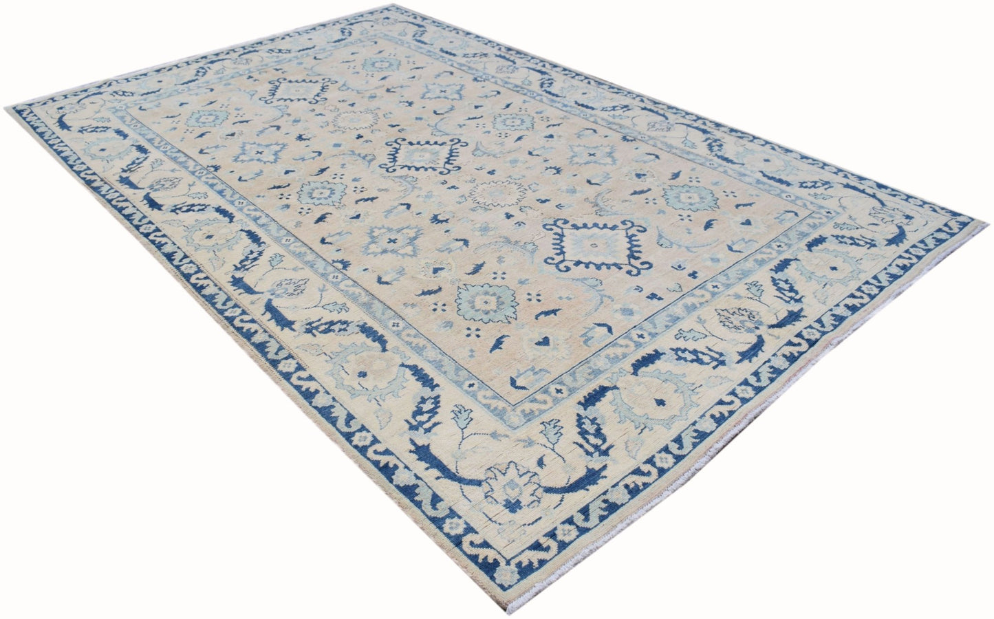 Handmade Afghan Kazakh rug featuring traditional blue and cream geometric patterns.
