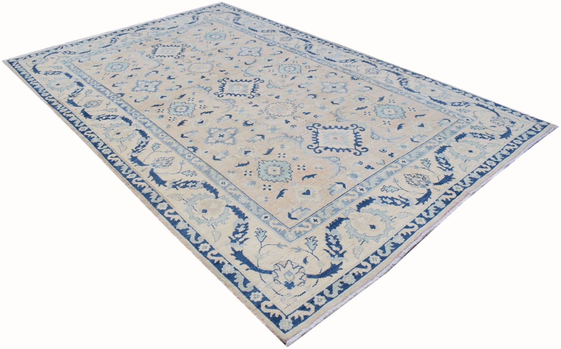 Handmade Afghan Kazakh rug featuring traditional blue and cream geometric patterns.