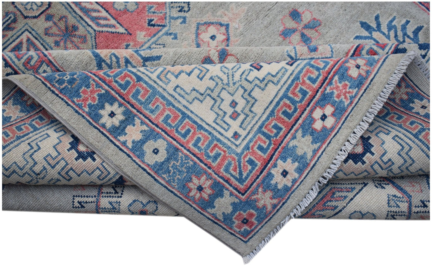 A handmade Afghan Kazakh rug featuring traditional geometric motifs in blue, pink, and cream wool.