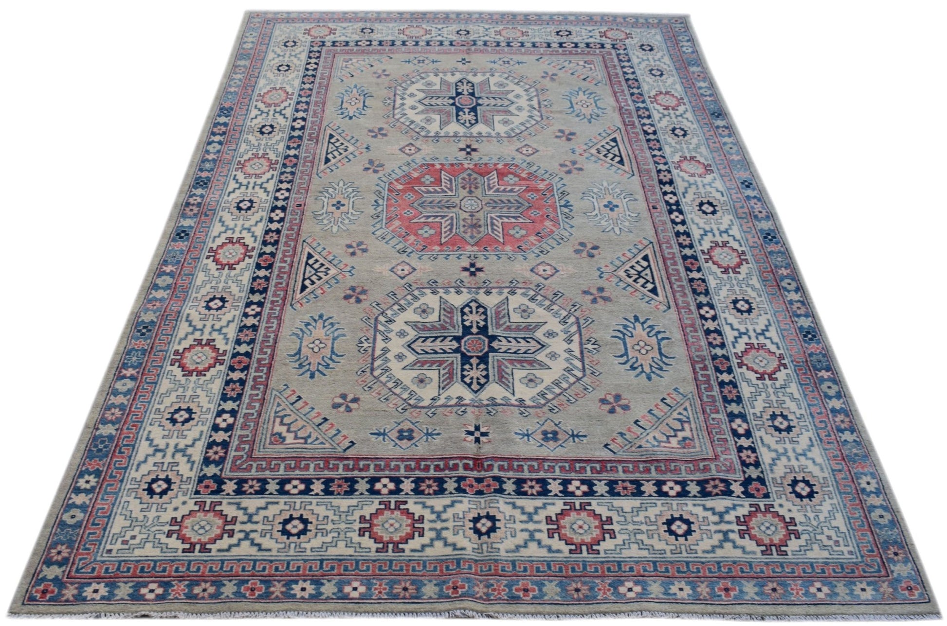 Handmade Afghan Kazakh rug featuring traditional geometric motifs in blue, red, and cream tones.