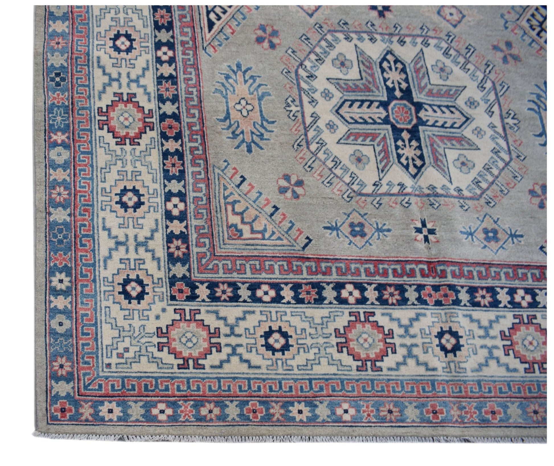 Handmade Afghan Kazakh rug featuring traditional geometric motifs in blue, red, and cream wool.