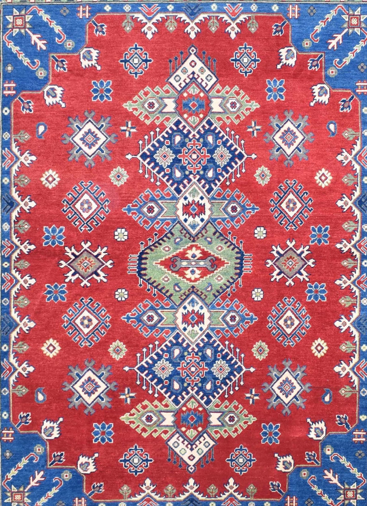 Handmade Afghan Kazakh rug featuring a geometric medallion pattern in red, blue, and green wool.