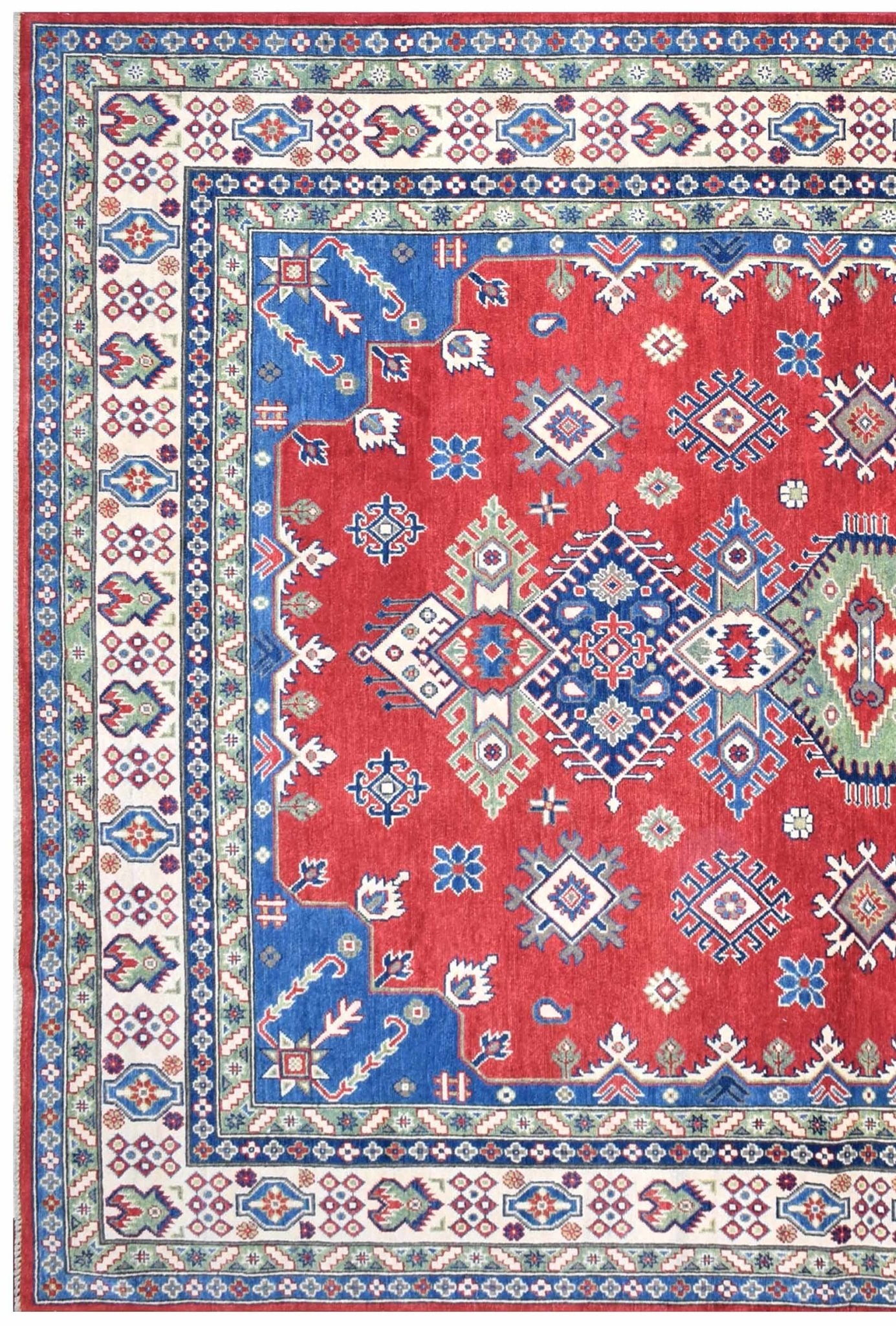 Handmade Afghan Kazakh rug featuring a red field with blue geometric medallions and floral borders.