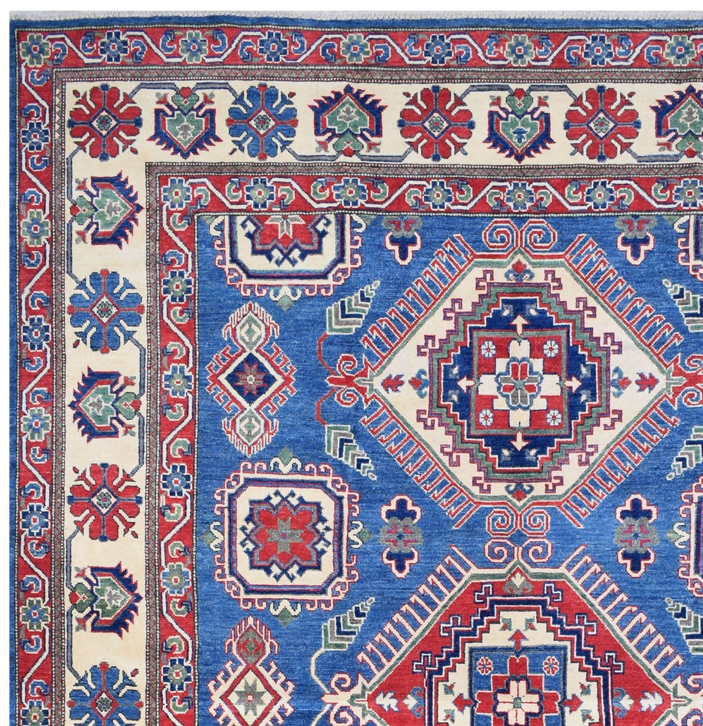 Handmade Afghan Kazakh rug featuring a geometric pattern in blue, red, and cream wool.