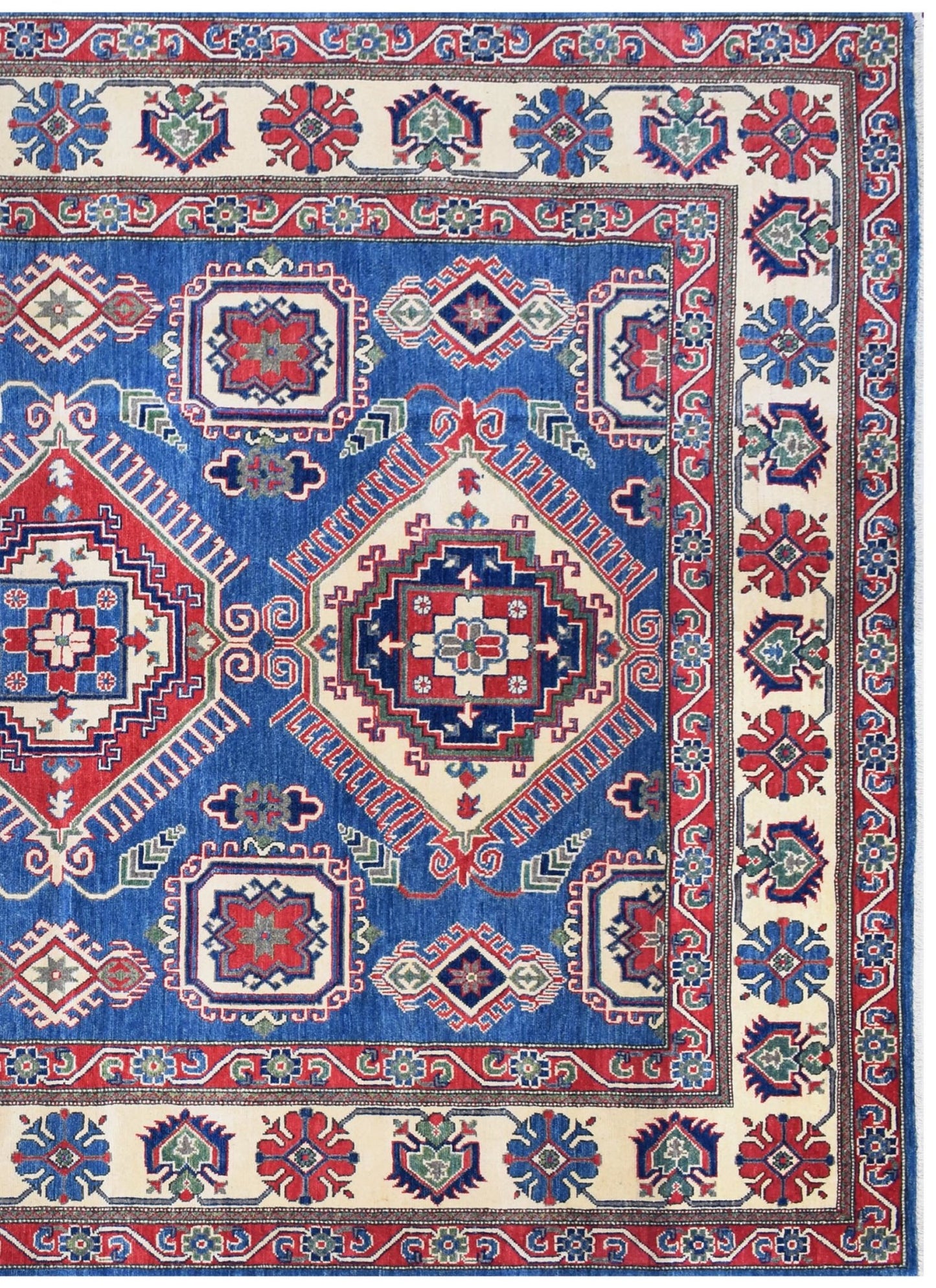 Handmade Afghan Kazakh rug featuring geometric medallions in red, blue, and cream wool.