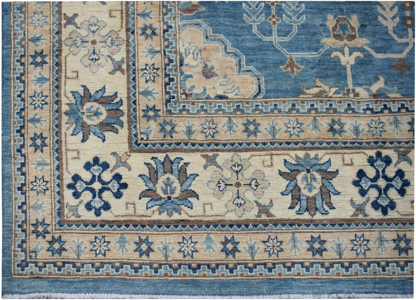 A handmade Afghan Kazakh rug featuring a blue and beige floral pattern with a geometric border.