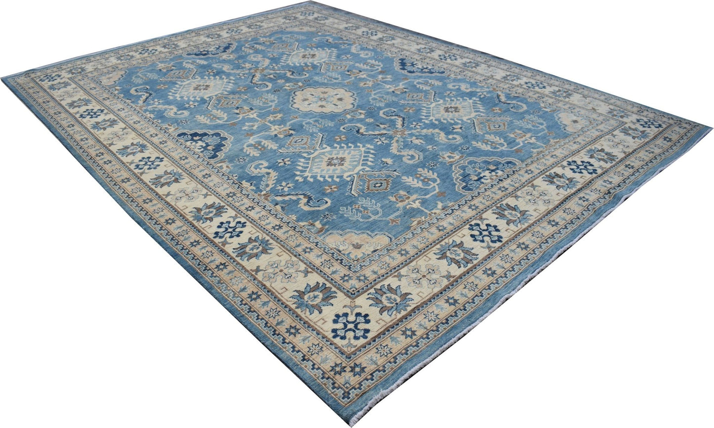 A handmade Afghan Kazakh rug featuring a blue field with intricate beige and grey geometric motifs.