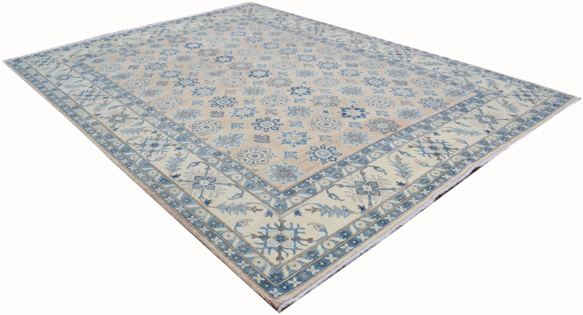 Handmade Afghan Kazakh rug featuring a traditional floral pattern in blue on a beige background.