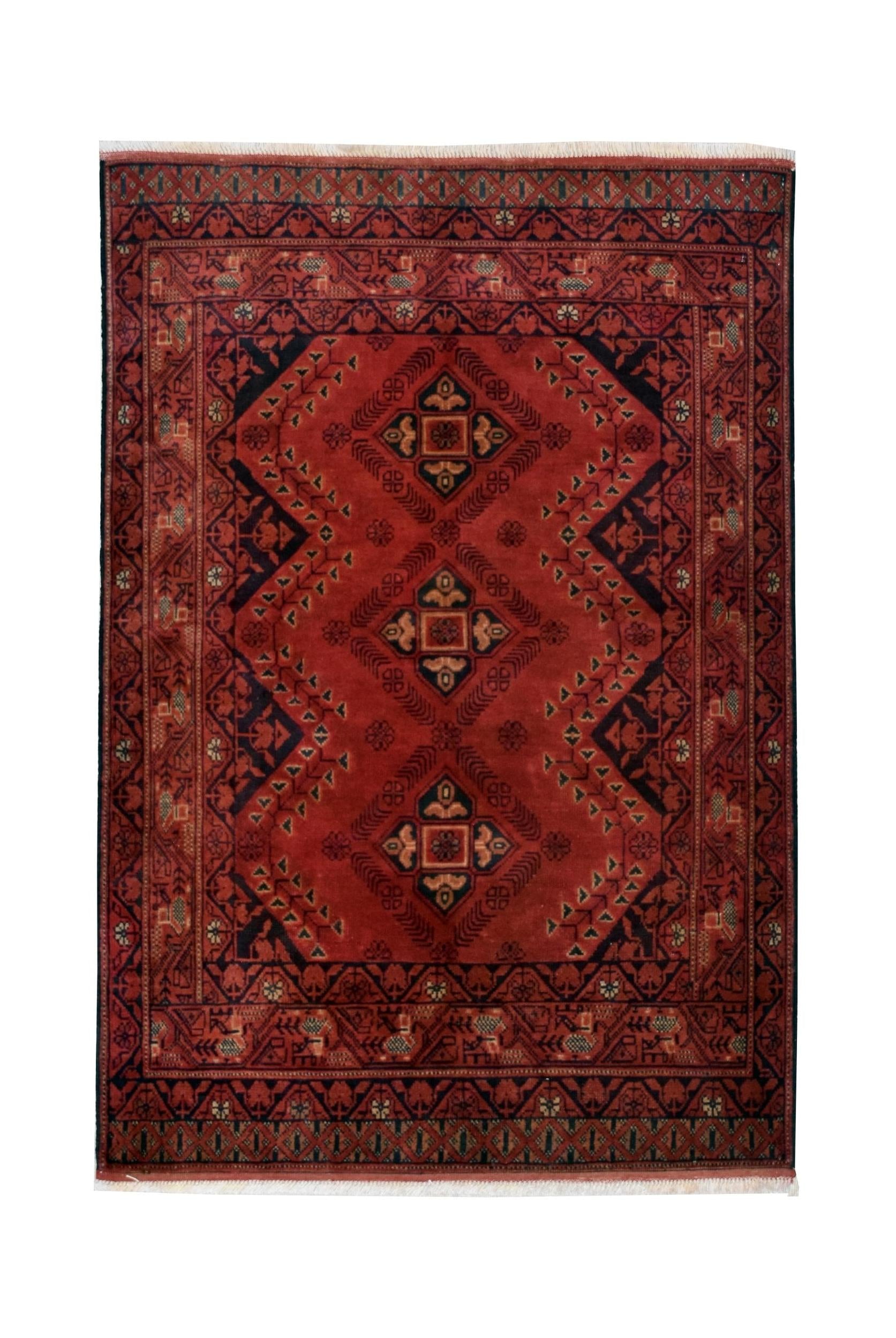Handmade Afghan Khal Mohammadi wool rug featuring a deep red field with geometric patterns.