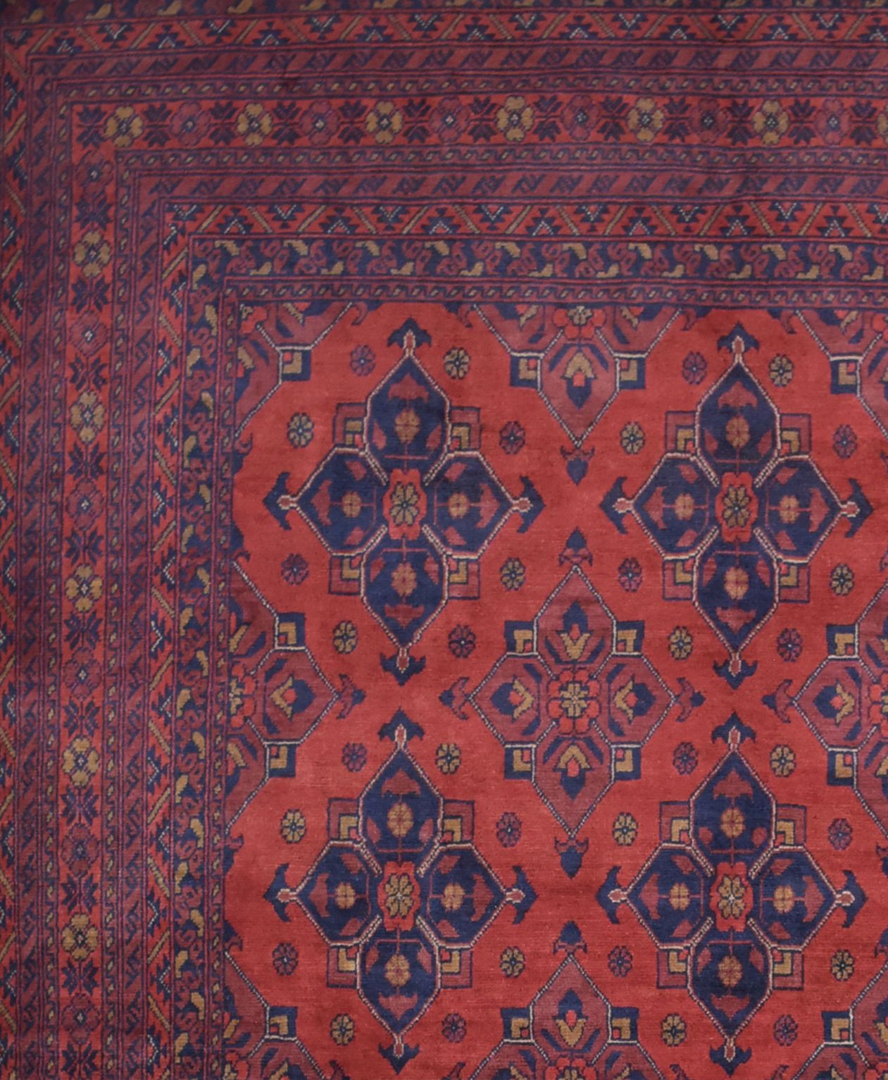 Handmade Afghan Khal Mohammadi rug featuring a deep red field with blue geometric floral motifs.