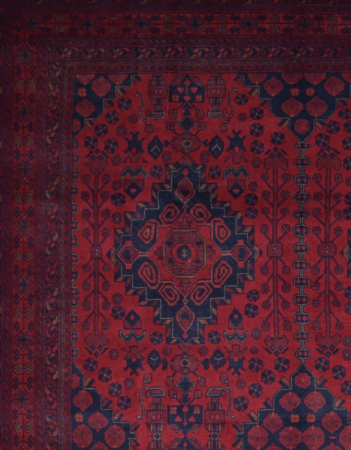Handmade Afghan Khal Mohammadi wool rug featuring deep red tones and geometric blue patterns.