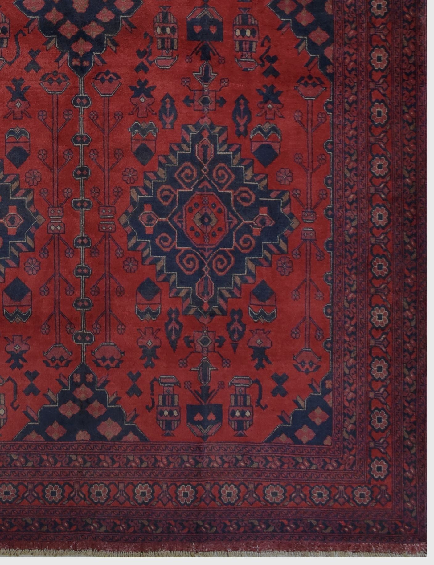 Handmade Afghan Khal Mohammadi wool rug featuring a deep red field with dark blue geometric motifs.