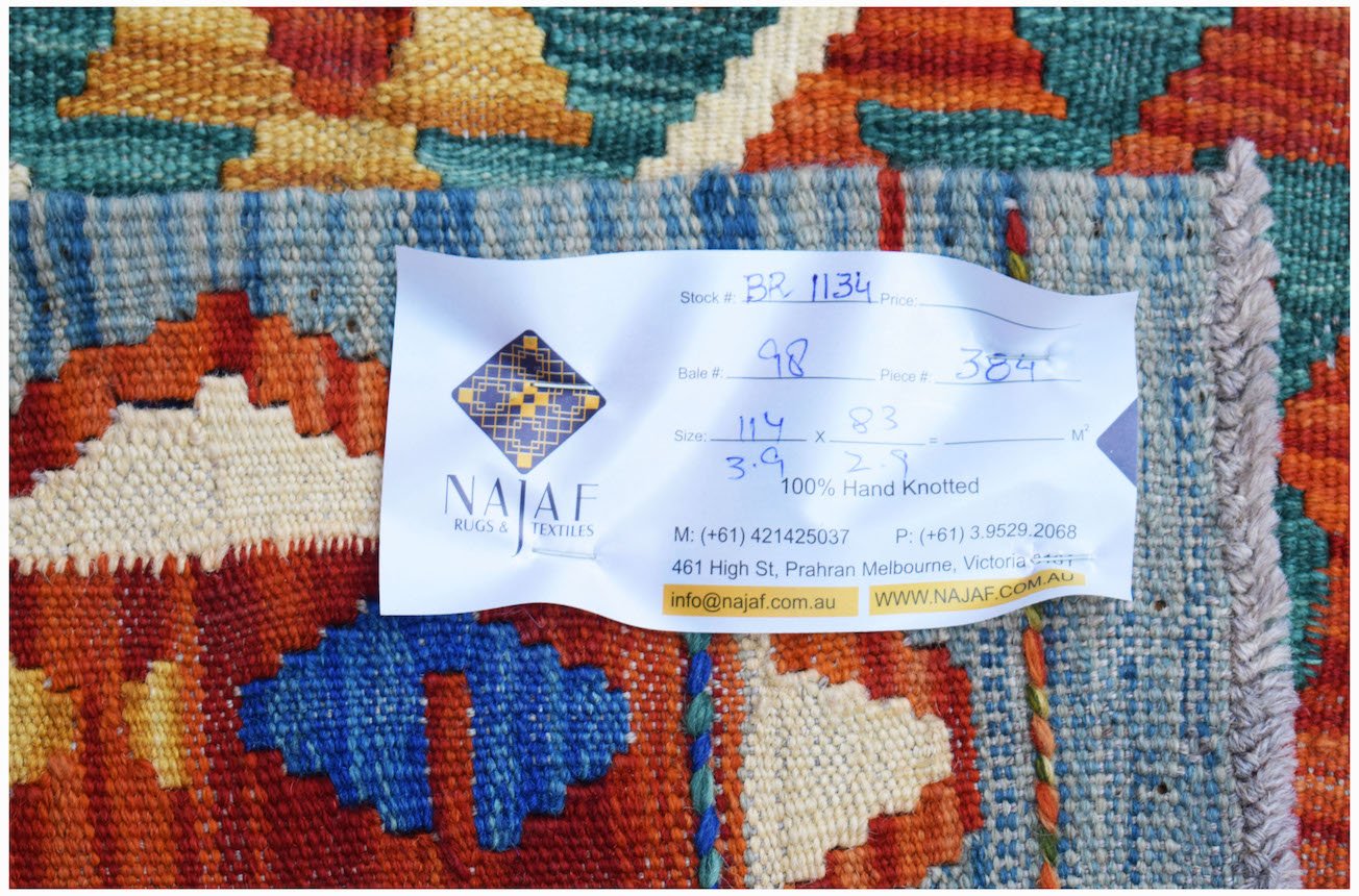 A close-up of a handwoven Afghan Maimana kilim featuring vibrant geometric patterns in wool.