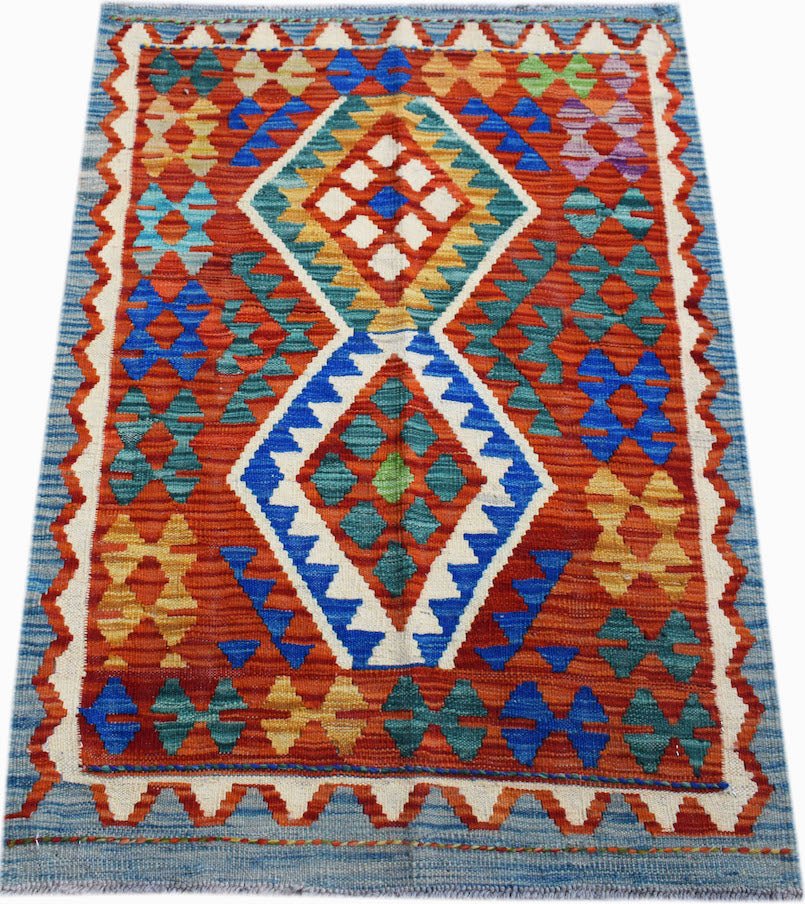 Handwoven Afghan Maimana kilim rug featuring a geometric diamond pattern in vibrant wool colors.