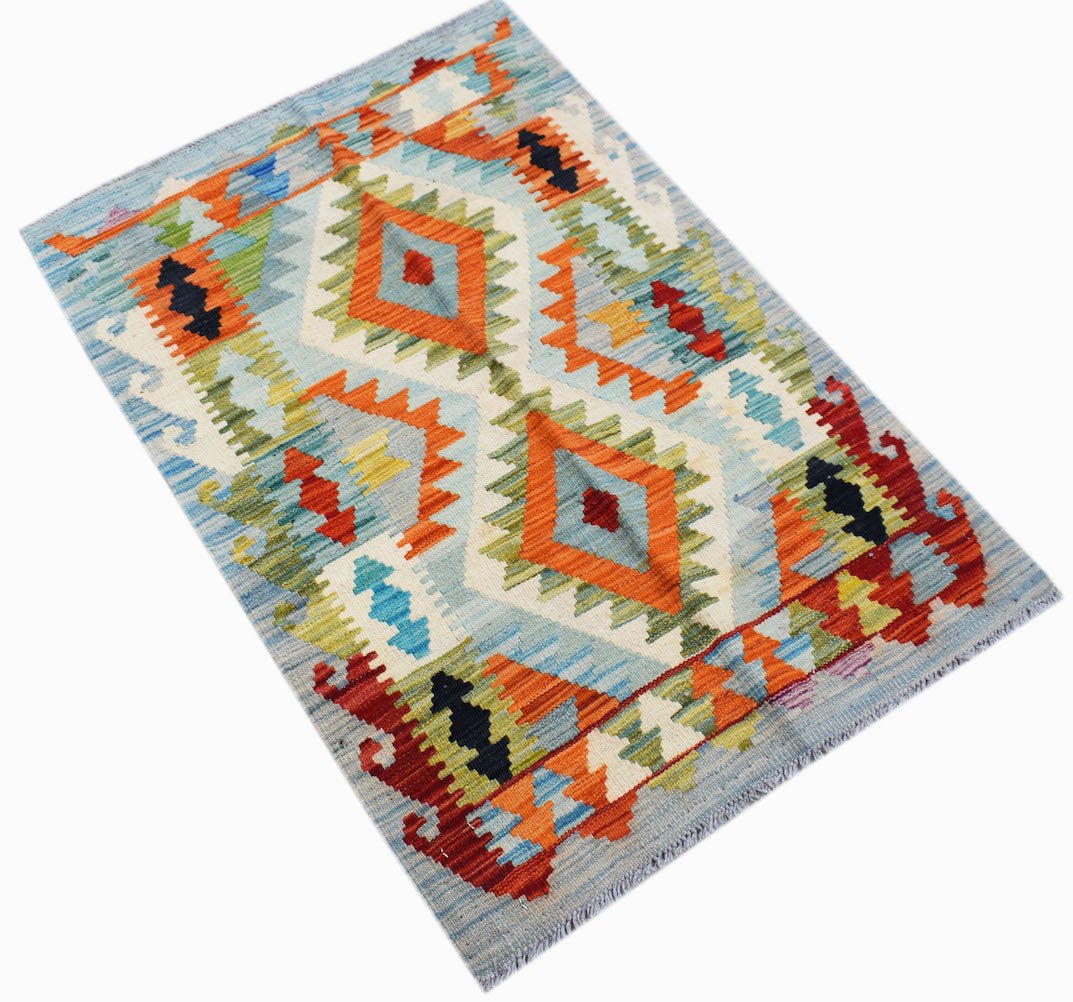 Handwoven Afghan Maimana kilim rug featuring a geometric diamond pattern in vibrant colors.