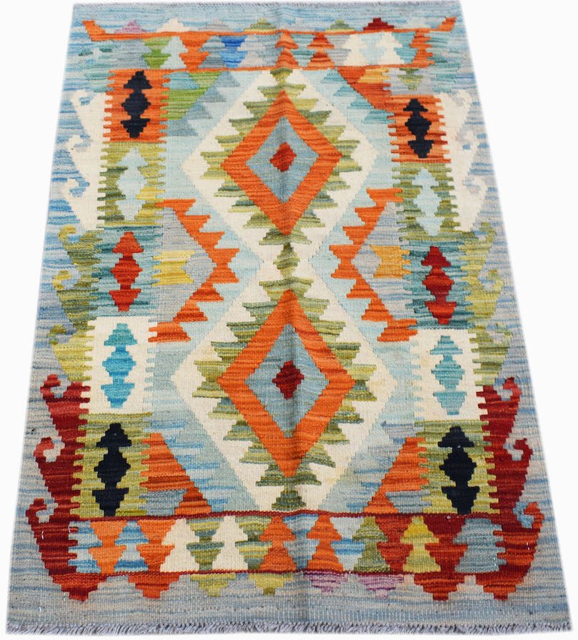 Handwoven Afghan Maimana kilim rug featuring a geometric diamond pattern in vibrant colors.